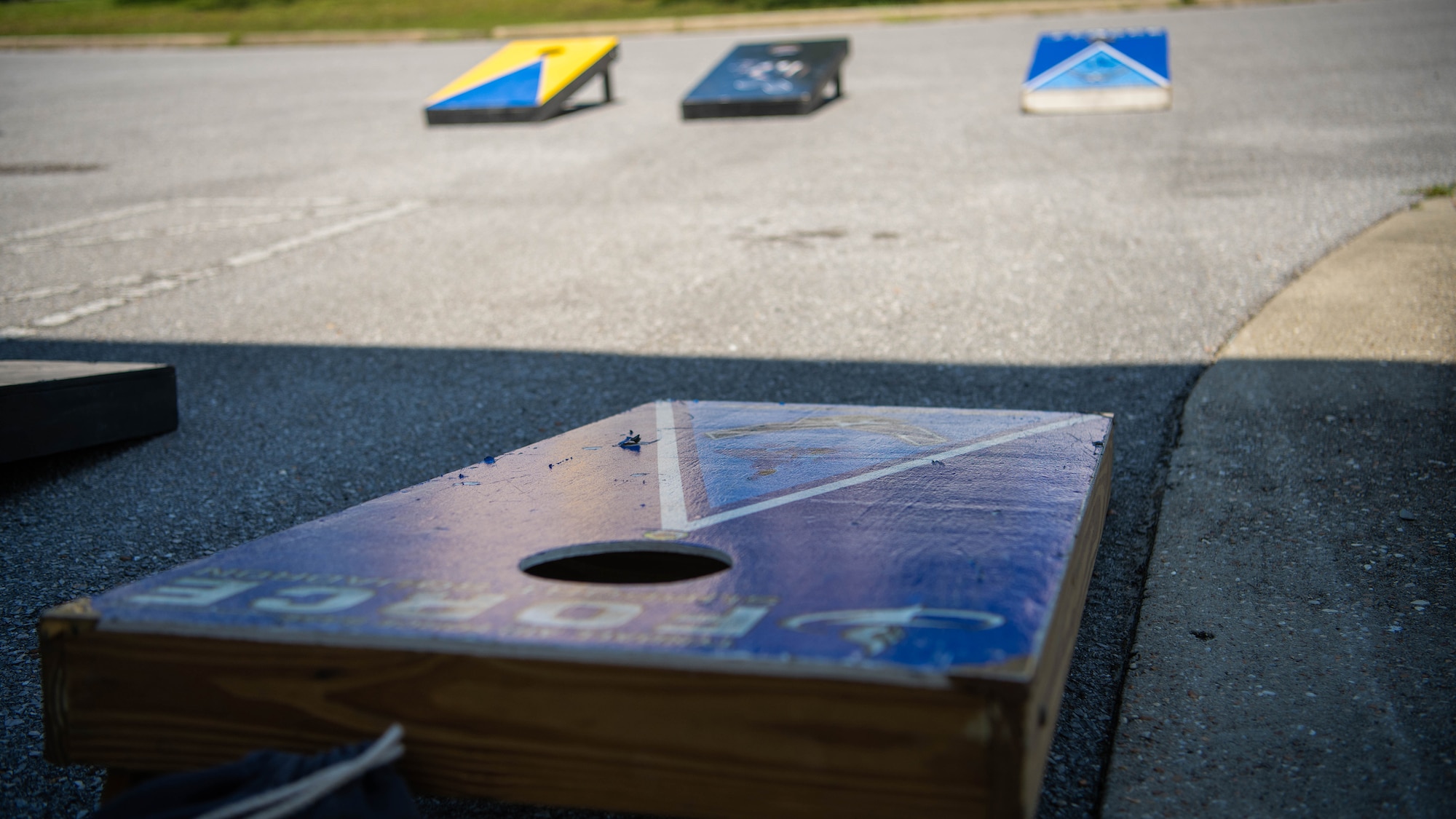 Cornhole board sits outside.