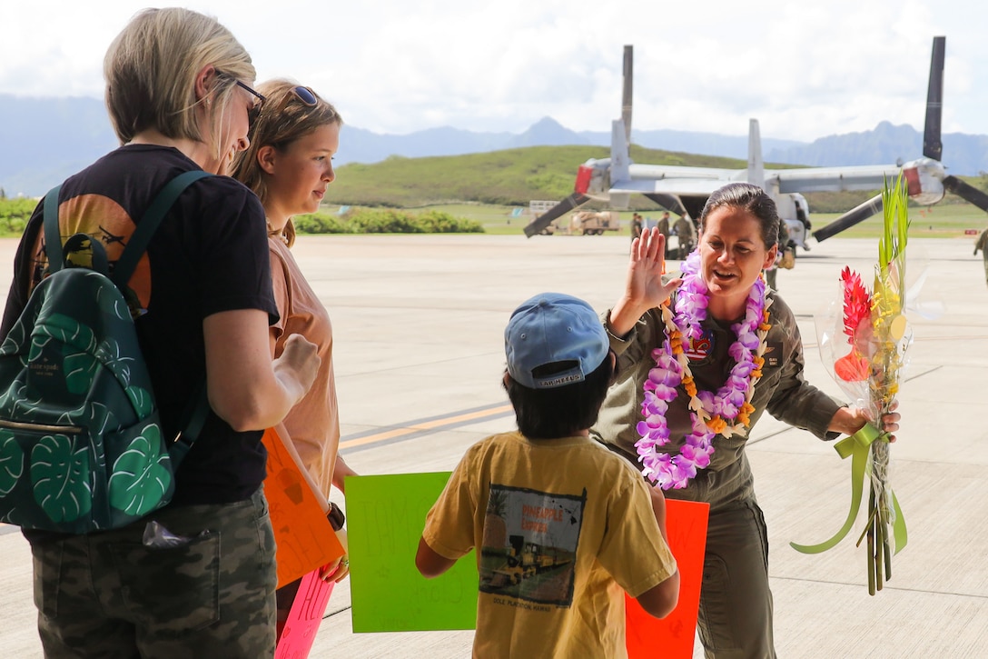 U.S. Marine Corps Lt. Col. Vanessa Clark, commanding officer, Marine Medium Tiltrotor Squadron 268, greets her family during the VMM-268 homecoming, Marine Corps Air Station Kaneohe Bay, Marine Corps Base Hawaii, Sept. 17, 2022. VMM-268 conducted a six day Trans-Pacific flight, concluding a six month long deployment, in support of the Marine Rotational Force-Darwin retrograde back to Hawaii. (U.S. Marine Corps photo by Lance Cpl. Chandler Stacy)
