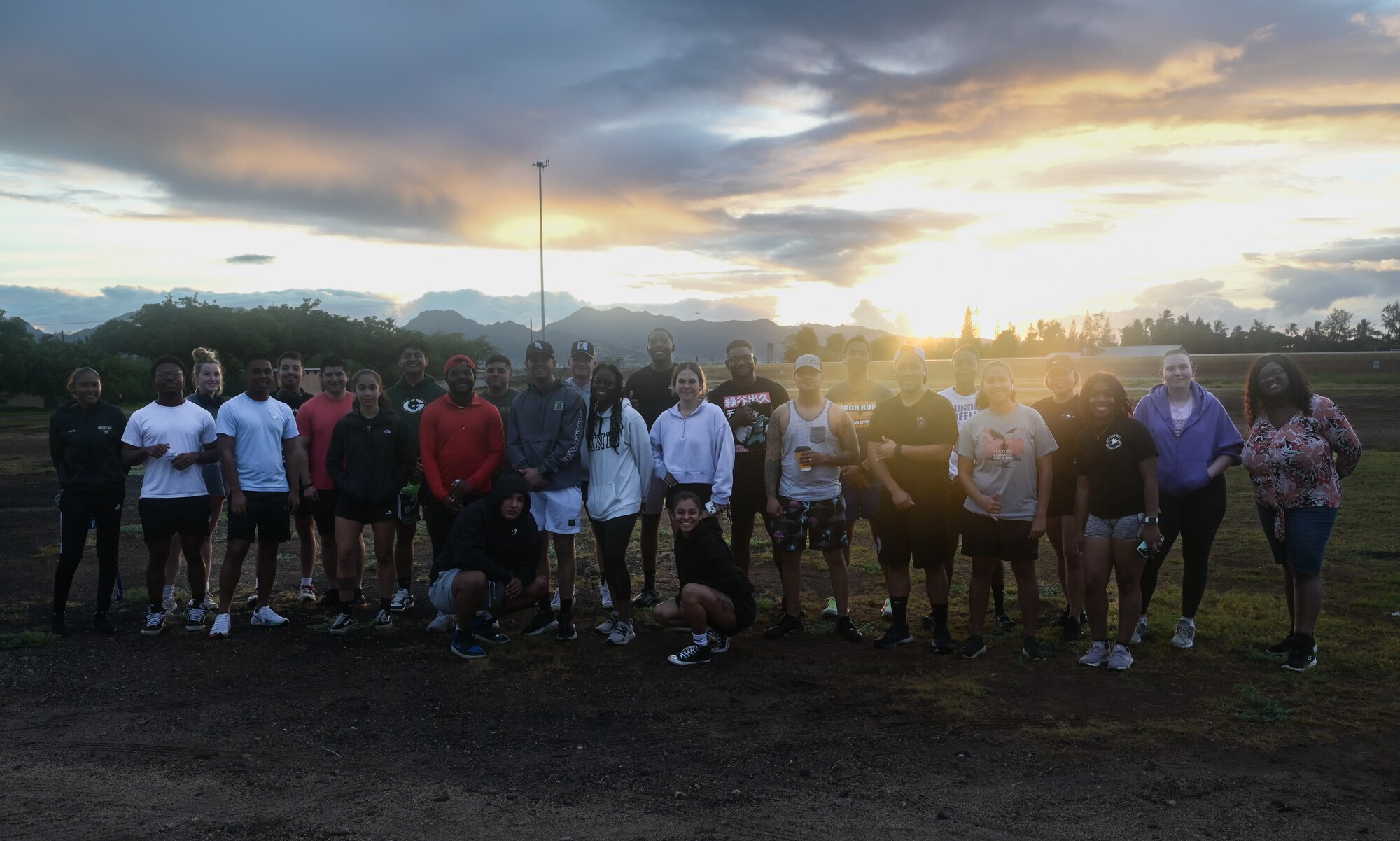 Run coordinators, volunteers and runners pose for a group photo before a 5K Fun Run at Joint Base Pearl Harbor-Hickam, Hawaii, Sept. 23, 2022. The 647th Security Forces Squadron partnered with the 15th Wing Violence Prevention Office to coordinate the run to increase awareness of Suicide Prevention Month. (U.S. Air Force photo by Staff Sgt. Alan Ricker)