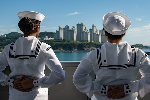 BUSAN, Republic of Korea (Sept. 23, 2022) Electrician’s Mate 3rd Class Katelyn Kangas, left, from Fairbanks, Alaska, and Logistics Specialist Seaman Diamond Perez, from New York, man the rails aboard the U.S. Navy’s only forward-deployed aircraft carrier, USS Ronald Reagan (CVN 76), as the ship pulls in to Busan, Republic of Korea, for a routine port visit. Ronald Reagan, the flagship of Carrier Strike Group 5, provides a combat-ready force that protects and defends the United States, and supports alliances, partnerships and collective maritime interests in the Indo-Pacific region. (U.S. Navy photo by Mass Communication Specialist 3rd Gorge Cardenas)