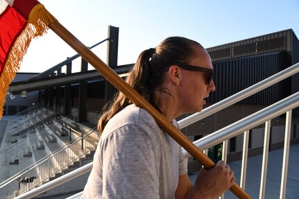 Tech. Sgt. Rachel Kane, 433rd Civil Engineer Squadron emergency management noncommissioned officer in charge, carries the guidon for the 9/11 memorial stair climb at Joint Base San Antonio-Lackland, Texas, Sept.11, 2022. The 433rd CES performs a stair climb every year to commemorate the 110 flights of stairs first responders had to climb inside the World Trade Center on Sept. 11, 2001. (U.S. Air Force photo by Staff Sgt. Adriana Barrientos)