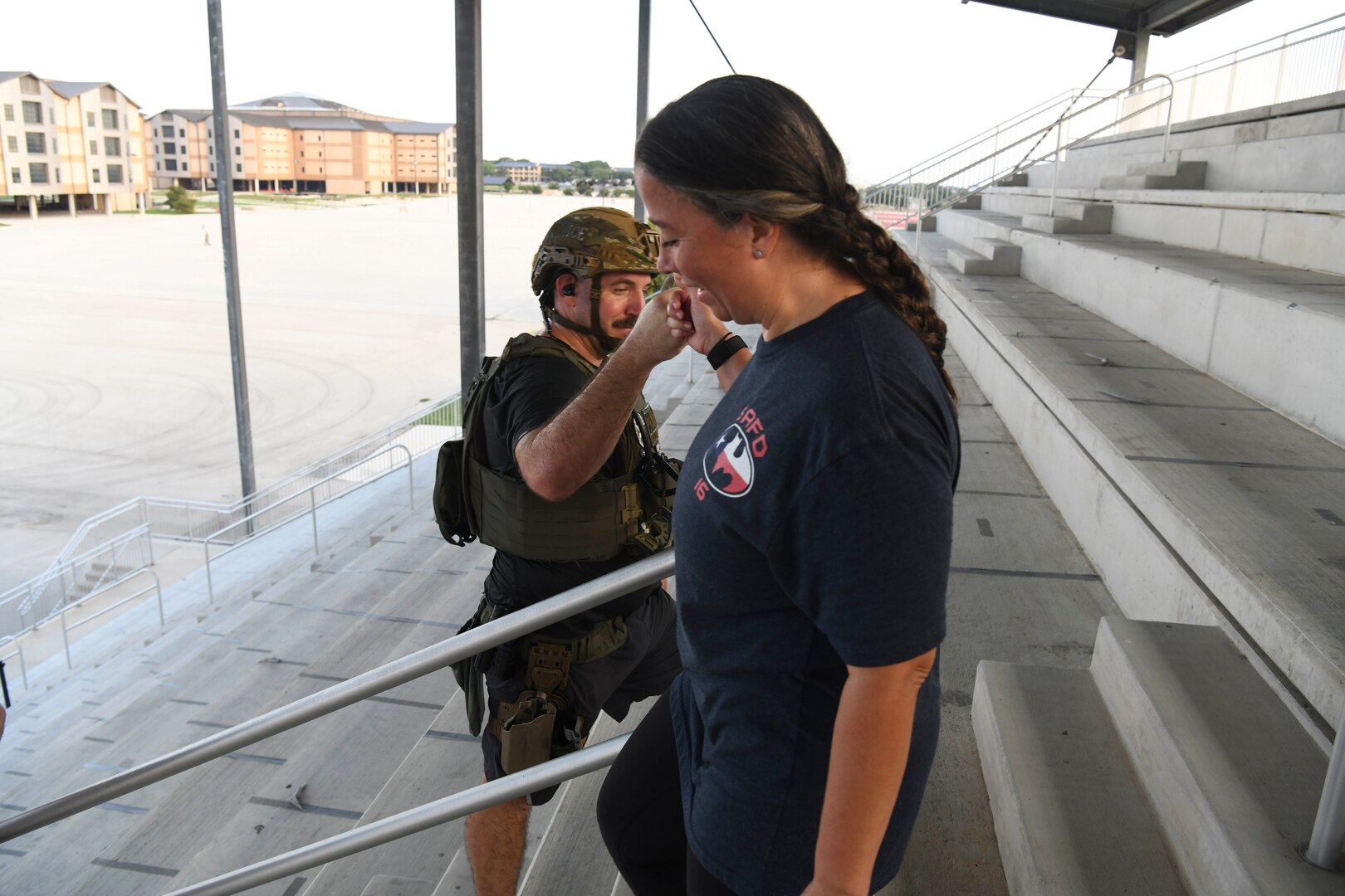 Maj. Leigh Barker, 433rd Civil Engineer Squadron commander, fist bumps Staff Sgt. Seth Lemountain, 433rd CES explosive ordnance disposal bomb technician, during the 9/11 memorial stair climb at Joint Base San Antonio-Lackland, Texas, Sept.11, 2022. The 433rd CES performs a stair climb every year to commemorate the 110 flights of stairs first responders had to climb inside the World Trade Center on Sept. 11, 2001. (U.S. Air Force photo by Staff Sgt. Adriana Barrientos)