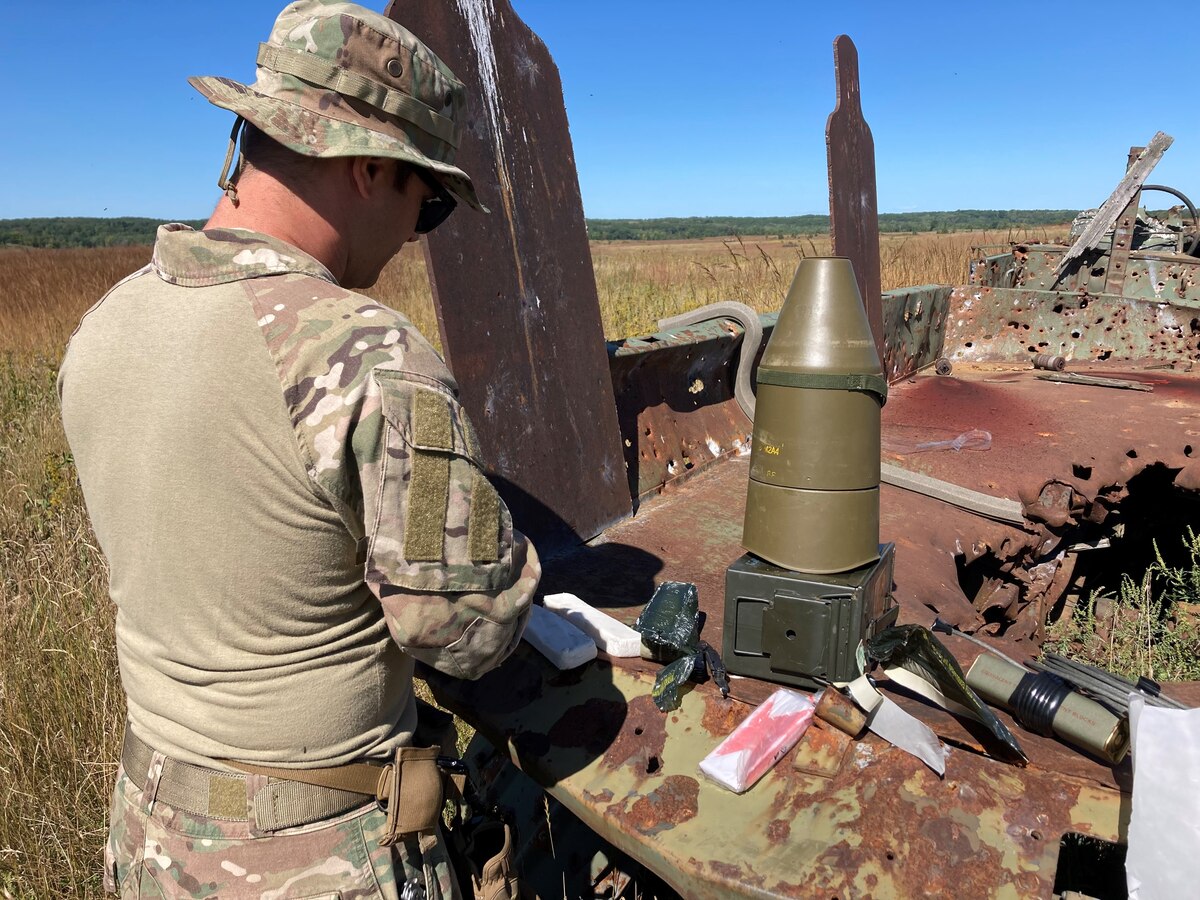 An Explosive Ordnance Disposal technician prepares an explosive charge as part of an explosive during the explosive effects training segment of the Advanced EOD Conventional Course held at Camp Ripley Training Center September 9-13, 2022.