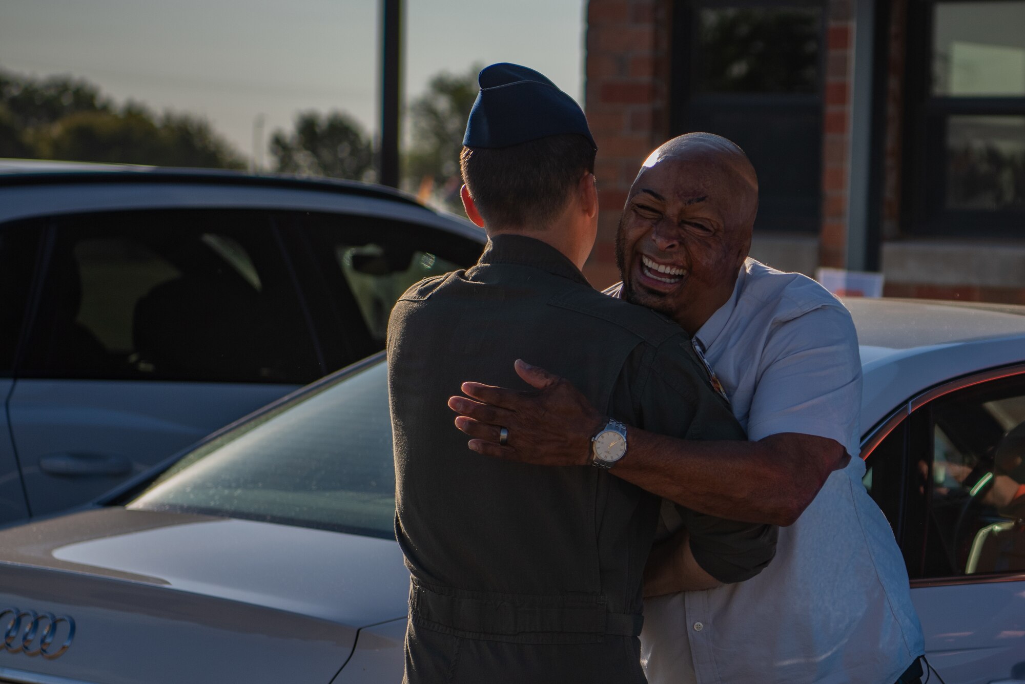 Col. Steven Wick, 317th Airlift Wing vice commander hugs J.R. Martinez, a combat veteran and motivational speaker, during the 317th AW resiliency training day at Dyess Air Force Base, Texas, Sept. 23, 2022. Resiliency training days serve to provide Airmen with the proper life skills to succeed both on and off duty. (U.S. Air Force photo by Airman 1st Class Ryan Hayman)
