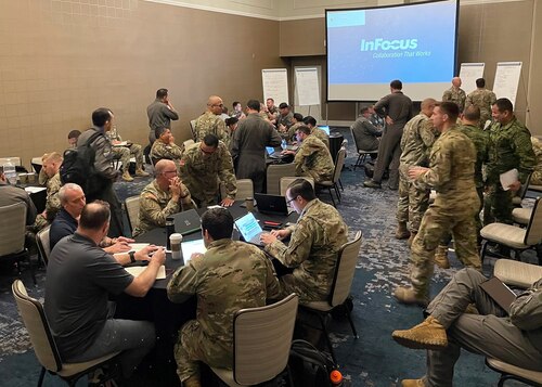 Photo of people sitting at tables with computers
