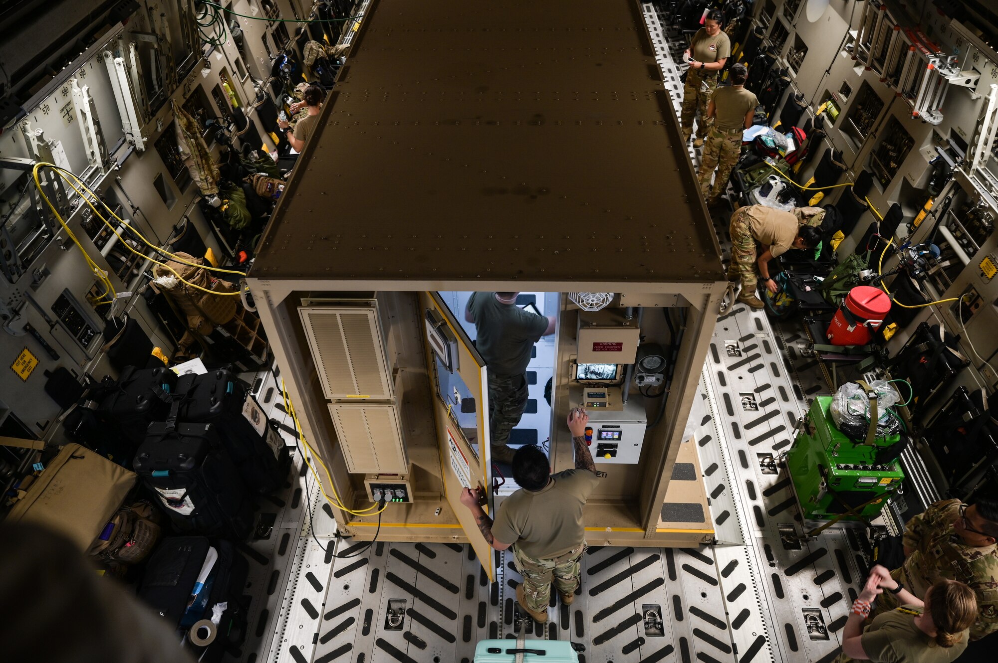 Airmen ready a Negative Pressure Conex-Lite for an infected patient on a C-17 Globemaster III at Joint Base Pearl Harbor-Hickam, Hawaii, Sept. 21, 2022. The NPCL is designed to treat and transport high-consequence infectious disease patients to minimize the risk of contamination and exposure. (U.S. Air Force photo by Staff Sgt. Alan Ricker)