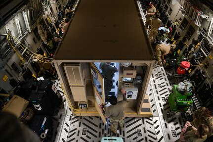 Airmen ready a Negative Pressure Conex-Lite for an infected patient on a C-17 Globemaster III at Joint Base Pearl Harbor-Hickam, Hawaii, Sept. 21, 2022. The NPCL is designed to treat and transport high-consequence infectious disease patients to minimize the risk of contamination and exposure. (U.S. Air Force photo by Staff Sgt. Alan Ricker)