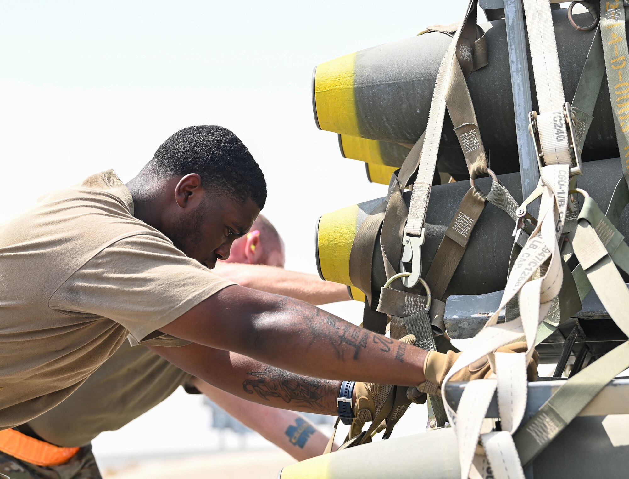 U.S. Air Force Airman 1st Class Nathaniel Battle, 379th Expeditionary Readiness Squadron Ground Transportation, pushes a pallet of munitions onto a K-loader Sept. 20, 2022 at Al Udeid Air Base, Qatar.  The 379th ERLS ground transport team moved munitions from the munitions storage area to a staging area where they were later loaded onto a C-17 Globemaster III aircraft. (U.S. Air National Guard photo by Master Sgt. Michael J. Kelly)