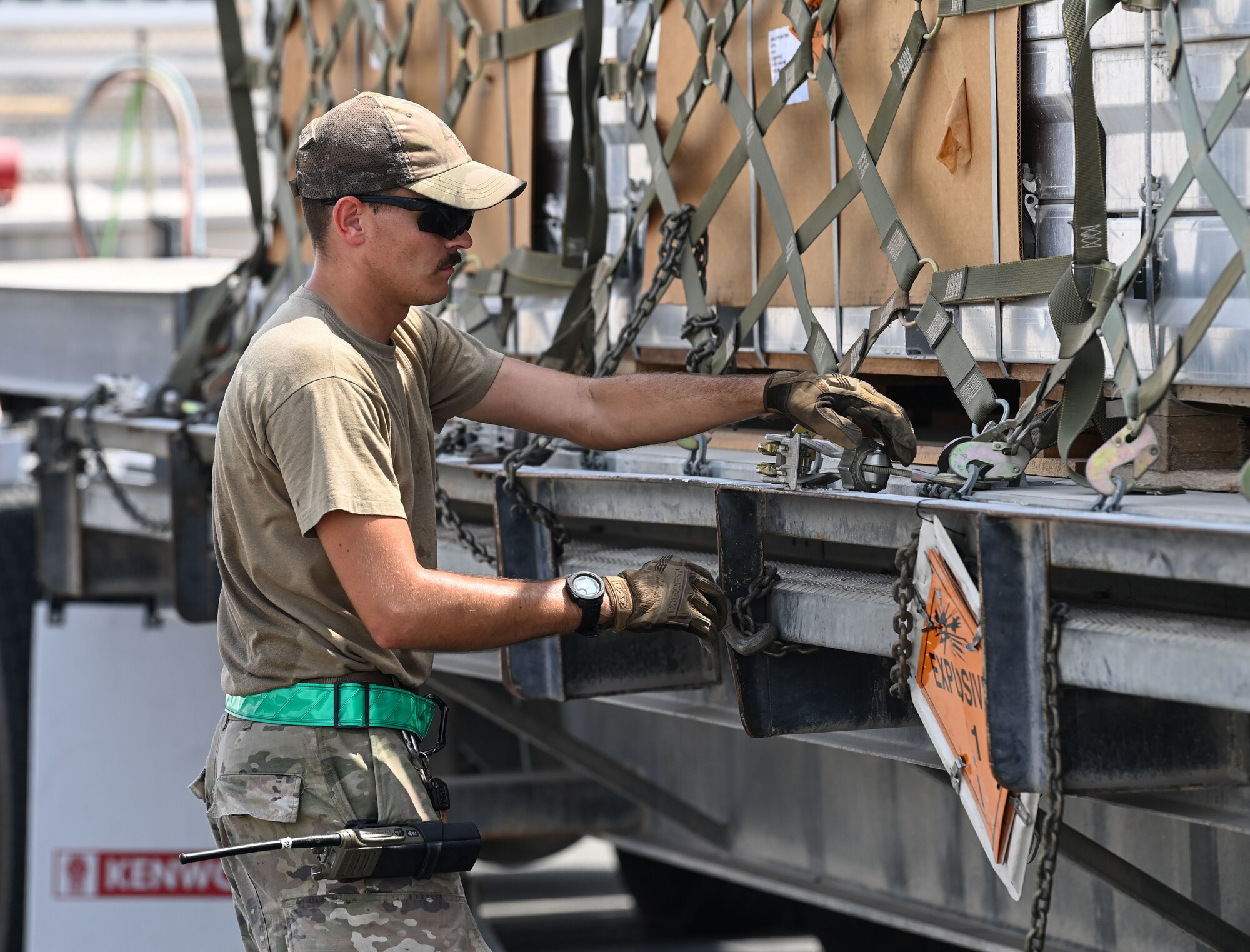U.S. Air Force Staff Sgt. Taylor Underwood, 379th Expeditionary Readiness Squadron Ground Transport, unties a pallet of munitions Sept. 20, 2022 at Al Udeid Air Base, Qatar.  The 379th ERLS ground transport team moved munitions from the munitions storage area to a staging area where they were later loaded onto a C-17 Globemaster III aircraft. (U.S. Air National Guard photo by Master Sgt. Michael J. Kelly)
