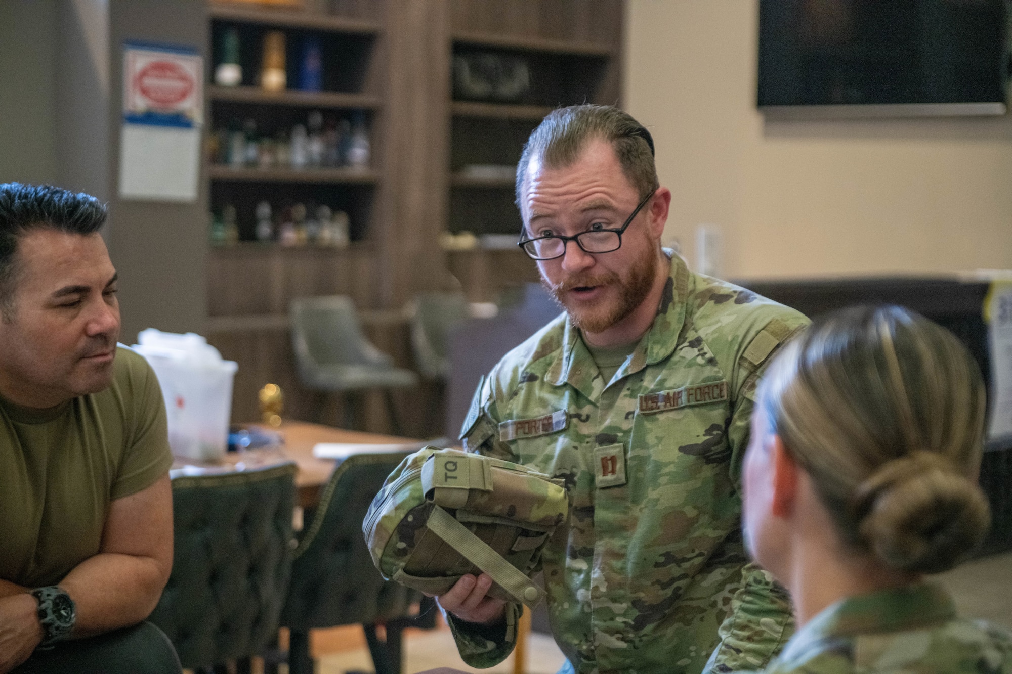 U.S. Air Force Capt. Daniel Porter, a clinical nurse with the 379th Expeditionary Operational Medical Readiness Squadron, explains aspects of the Individual First Aid Kit during a training exercise at Al Udeid Air Base, Qatar, Sept. 23, 2022. The IFAK is meant to be carried and used by one person. (U.S. Air National Guard photo by Airman 1st Class Constantine Bambakidis)