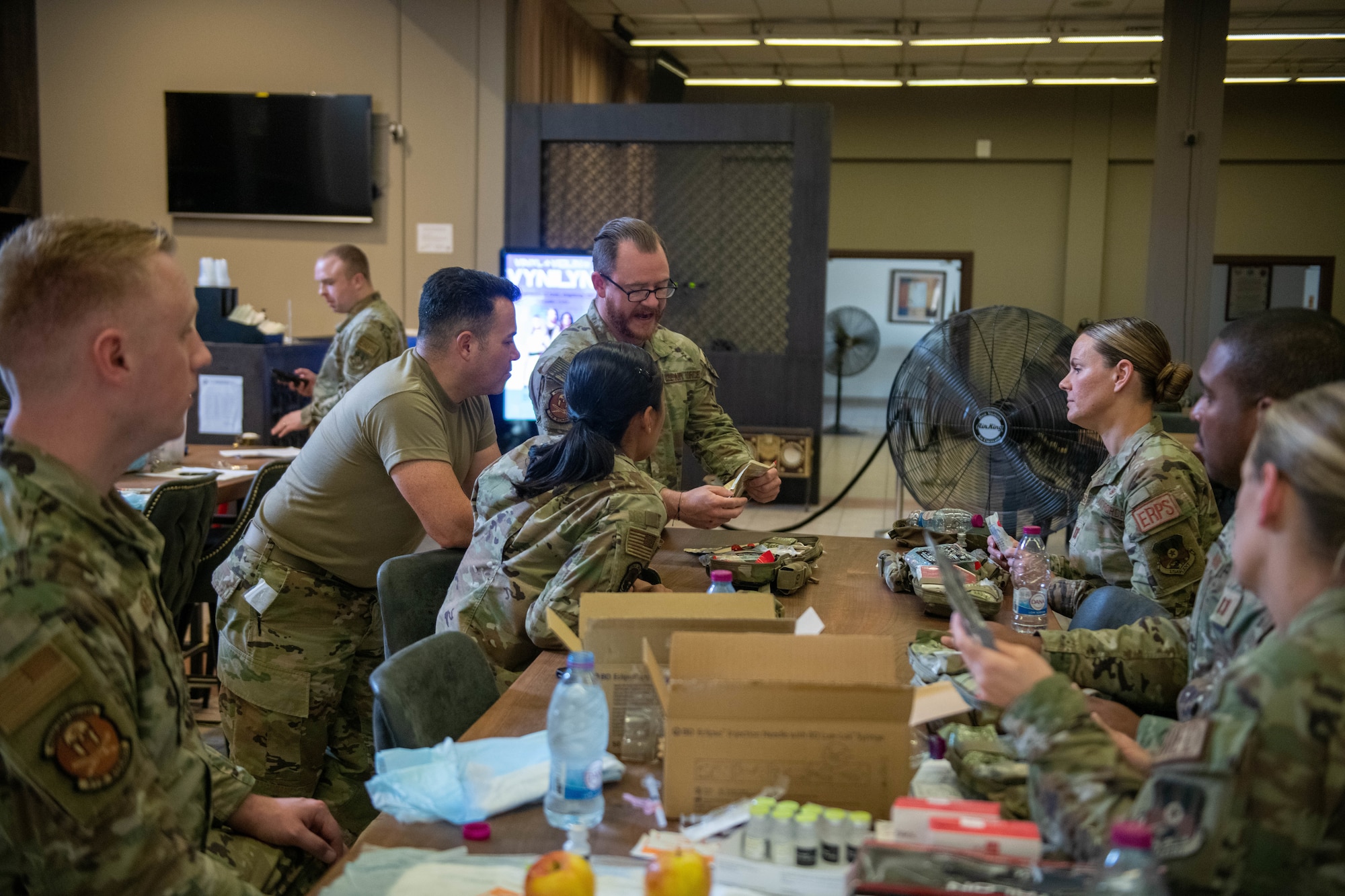 Airmen assisgned to the  379th Expeditionary Operational Medical Readiness Squadron, study the use of an Individual First Aid Kit during a training exercise at Al Udeid Air Base, Qatar, Sept. 23, 2022. Frequent training ensures airmen are prepared to effectively respond to situations. (U.S. Air National Guard photo by Airman 1st Class Constantine Bambakidis)