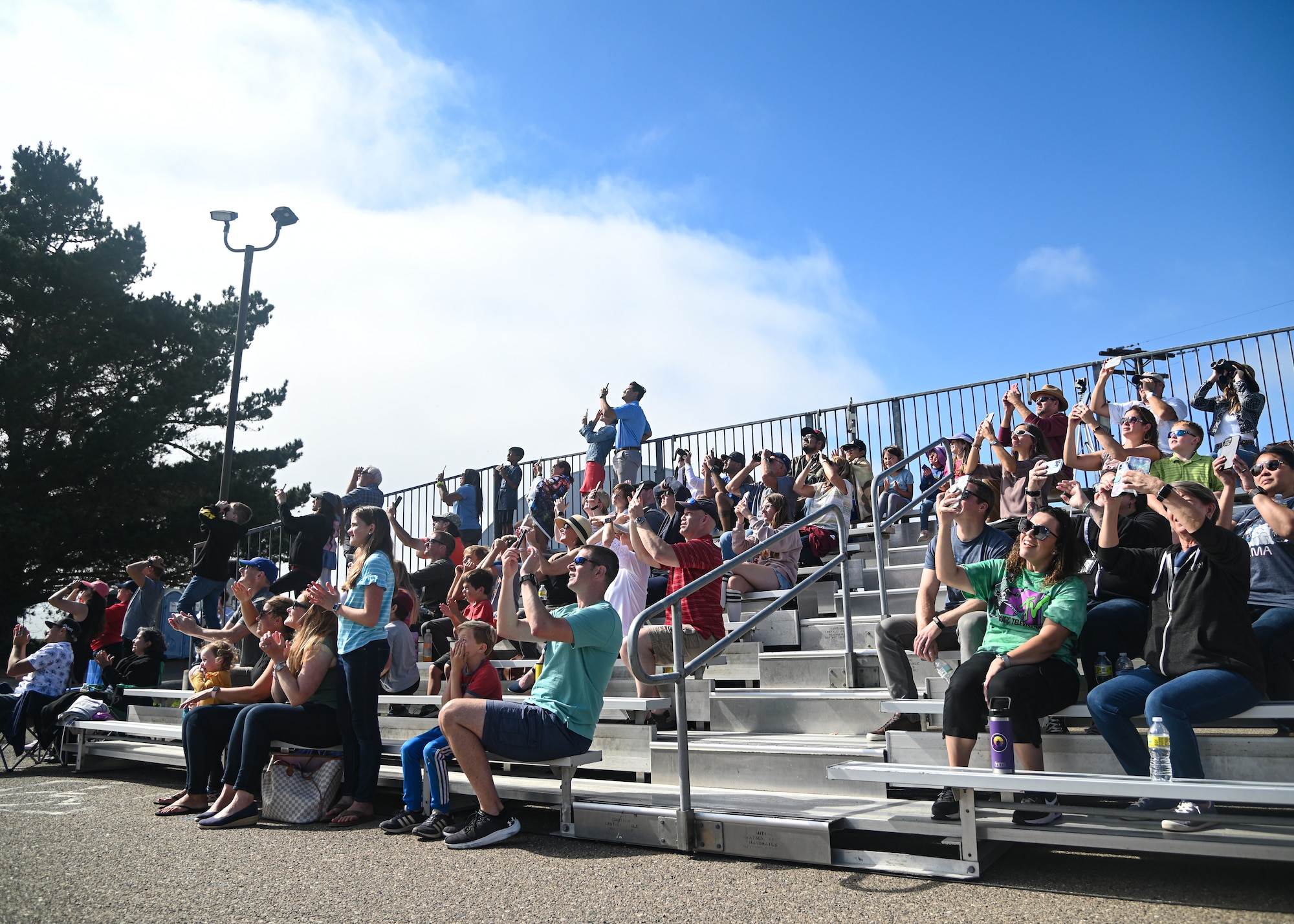 People watch on as a rocket goes into the sky