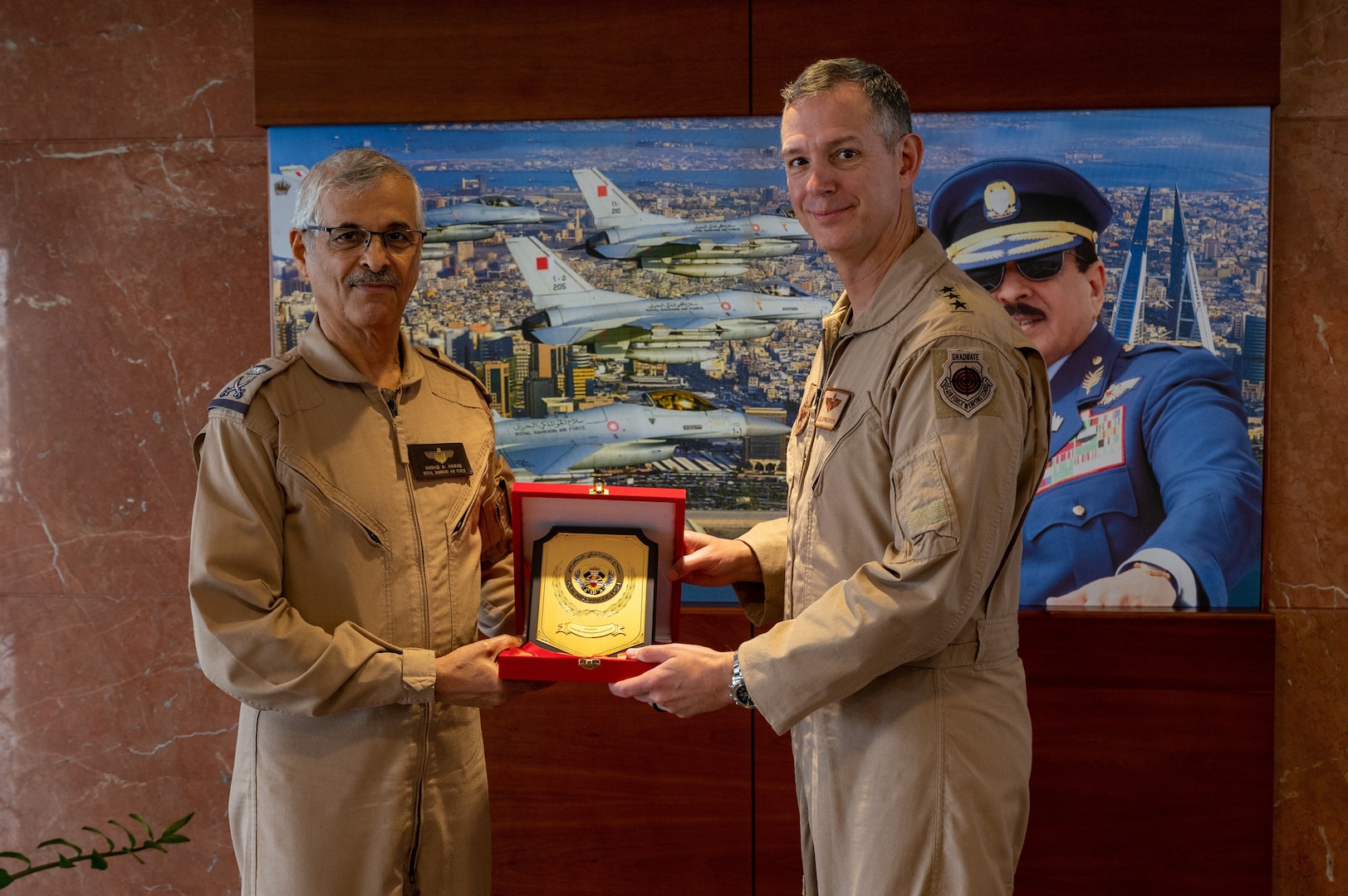 Lt. Gen. Alexus G. Grynkewich, Ninth Air Force (Air Forces Central) commander (right), receives a gift from Maj. Gen. Hamad bin Abdullah al Khalifah, Royal Bahraini Air Force commander, at a military facility in Bahrain, Sep. 5 2022. During his visit, Grynkewich met with Bahraini military and embassy leaders to better integrate military operations, strengthen resolute partnerships and ensure security within the U.S. Central Command area of responsibility (US. Air Force photo by Senior Airman Dominic Tyler)