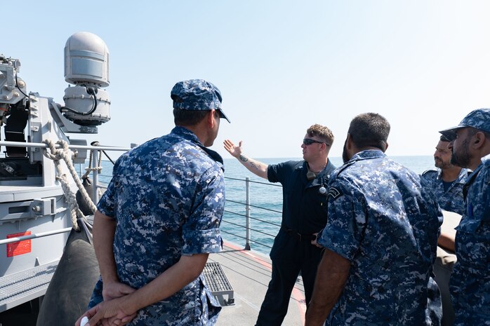 220920-N-ZA692-1305 ARABIAN GULF (Sept. 20, 2022) Gunner’s Mate 1st Class Nathan Rattelade conducts MK 38 Mod 2 25mm machine gun system training aboard patrol coastal ship USS Chinook (PC 9) with Royal Bahrain Naval Force personnel in the Arabian Gulf, Sept. 20. Chinook conducted a three-day professional exchange that ended Sept. 21.