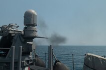 220920-N-ZA692-1443 ARABIAN GULF (Sept. 20, 2022) An MK 38 Mod 2 25mm machine gun system fires a round aboard patrol coastal ship USS Chinook (PC 9) during training with the Royal Bahrain Naval Force in the Arabian Gulf, Sept. 20. Chinook conducted a three-day professional exchange that ended Sept. 21.