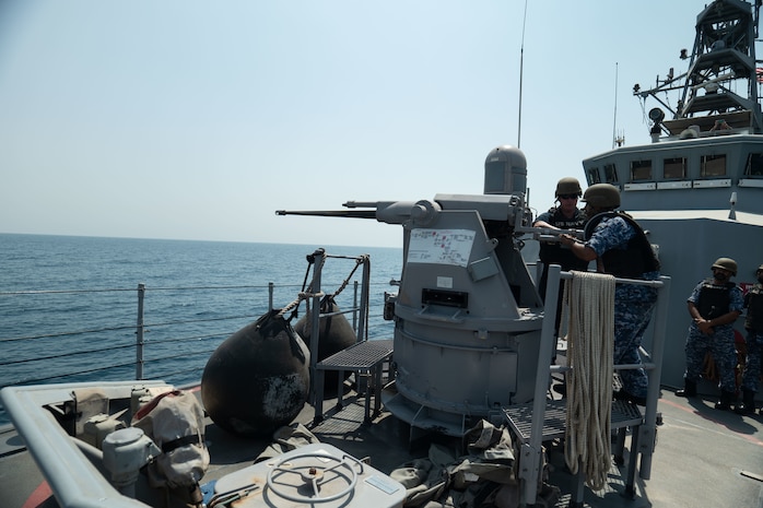 220920-N-ZA692-1507 ARABIAN GULF (Sept. 20, 2022) A Sailor from the Royal Bahrain Naval Force shoots an MK 38 Mod 2 25mm machine gun system aboard patrol coastal ship USS Chinook (PC 9), Sept. 20. Chinook conducted a three-day professional exchange that ended Sept. 21.