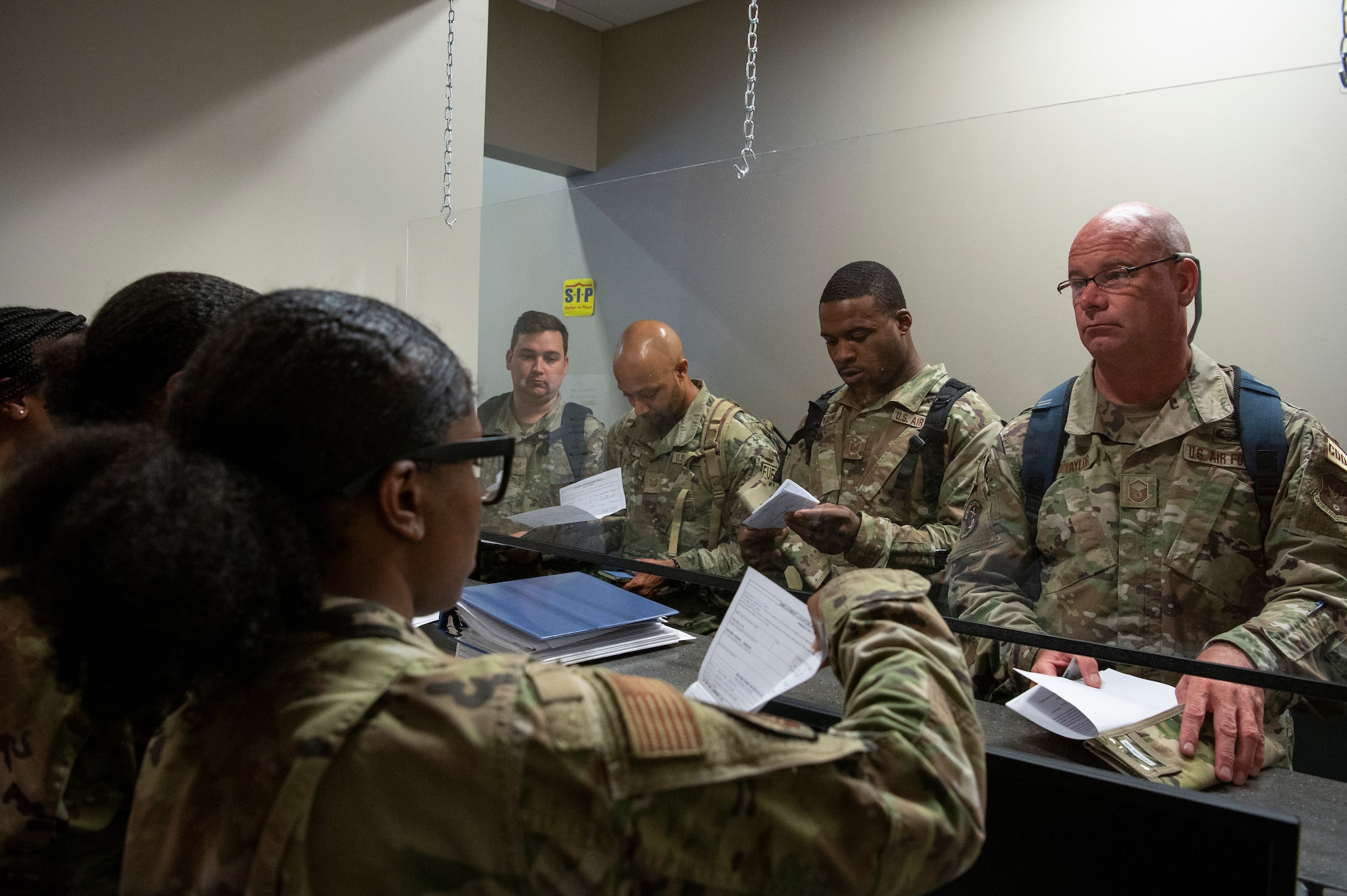 Members of the 94th Airlift Wing simulate base out-processing procedures during an exercise at Dobbins Air Reserve Base, Ga. Sept. 21, 2022. Dobbins ARB hosted, coordinated, and participated in a base-wide exercise, called United Forces 22-01, from Sept. 19-25 to test readiness capabilities. (U.S. Air Force photo by Senior Airman Kendra A. Ransum)
