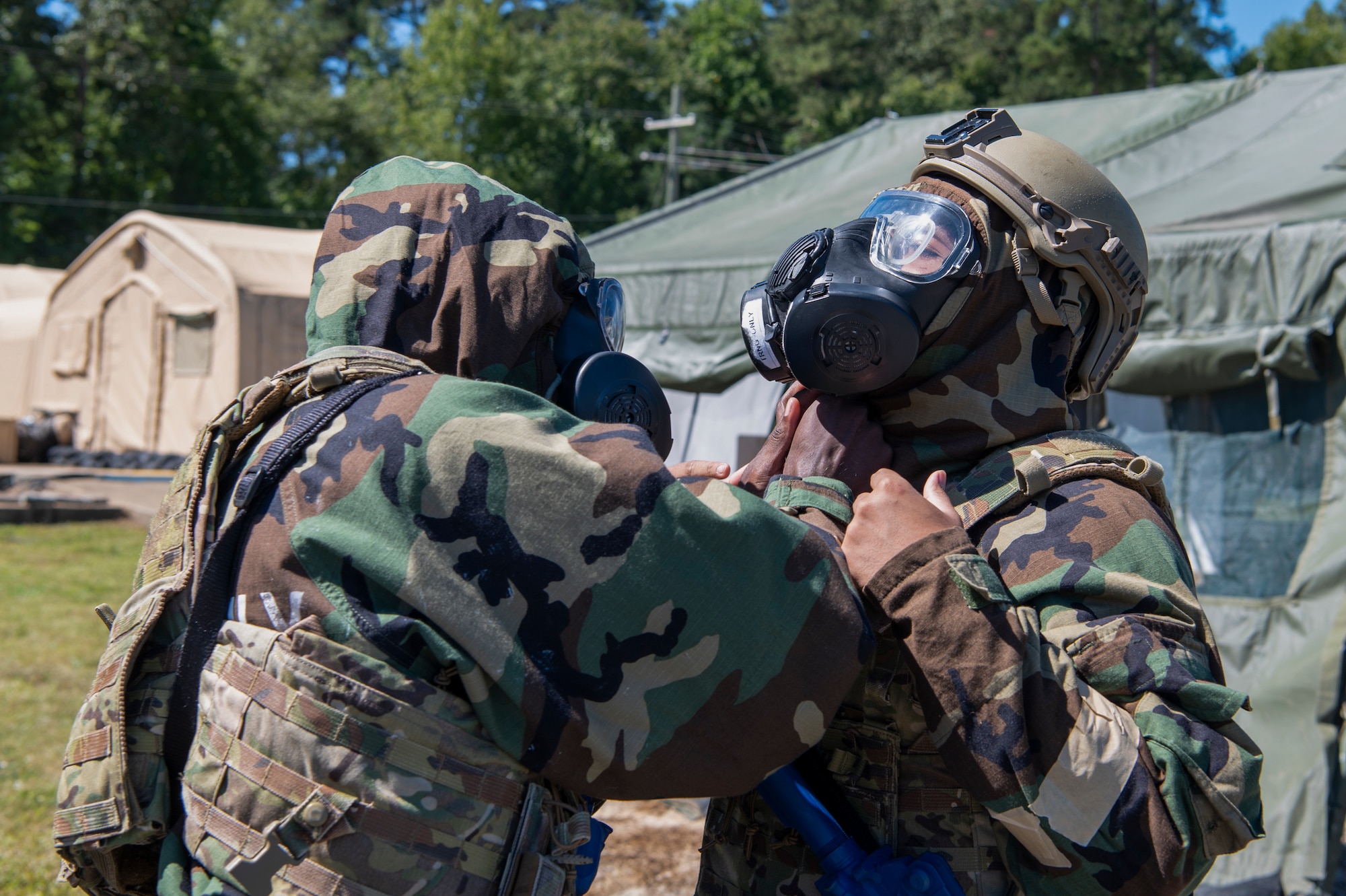 Staff Sgt. Timothy Wright, member of the 94th Security Forces Squadron, assists fellow squadron member Airman 1st Class Nicholas Yothbounpheng with suiting up in Mission Oriented Protective Posture gear at Dobbins Air Reserve Base, Ga. Sept. 23, 2022. Dobbins ARB hosted, coordinated, and participated in a base-wide exercise, called United Forces 22-01, from Sept. 19-25 to test readiness capabilities. (U.S. Air Force photo by Senior Airman Kendra A. Ransum)