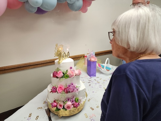 Alice Starnes prepares to blow out the candle on a birthday cake during a celebration of her 100th birthday.