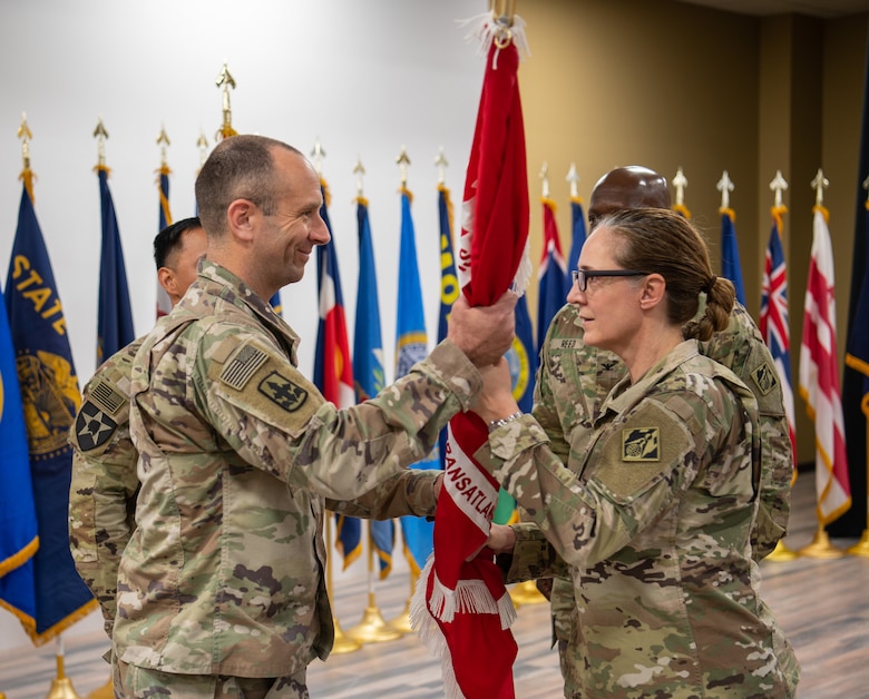 Lt. Col. Peter Ammerman receives the unit colors from Maj. Gen. Kimberly Colloton