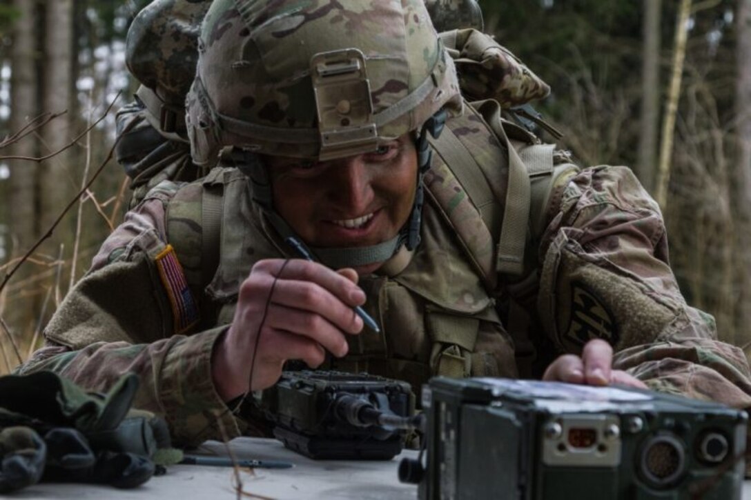 Soldier uses radio.