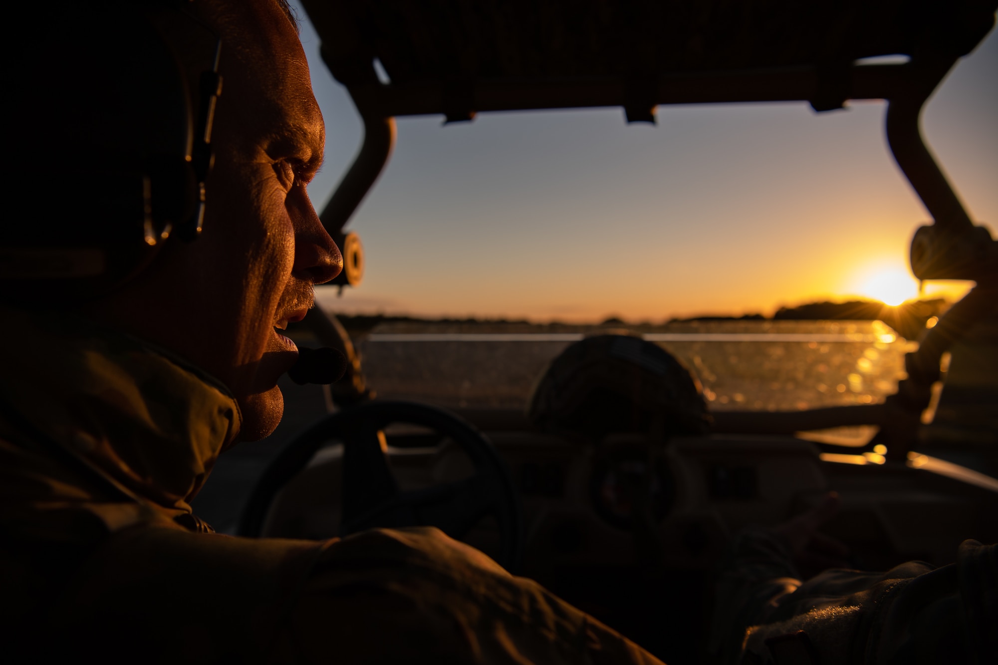 U.S. Air Force Tech. Sgt. Cameron Piontek, 435th Contingency Response Squadron airborne air traffic controller, drives a Polaris RZR vehicle during exercise Agile Wolf 22 at Koszalin, Poland, Sept. 13, 2022. Piontek searches for hazards along the landing zone then places visual markers to ensure the safety of the aircraft when it touches down. (U.S. Air Force photo by Airman 1st Class Jared Lovett)