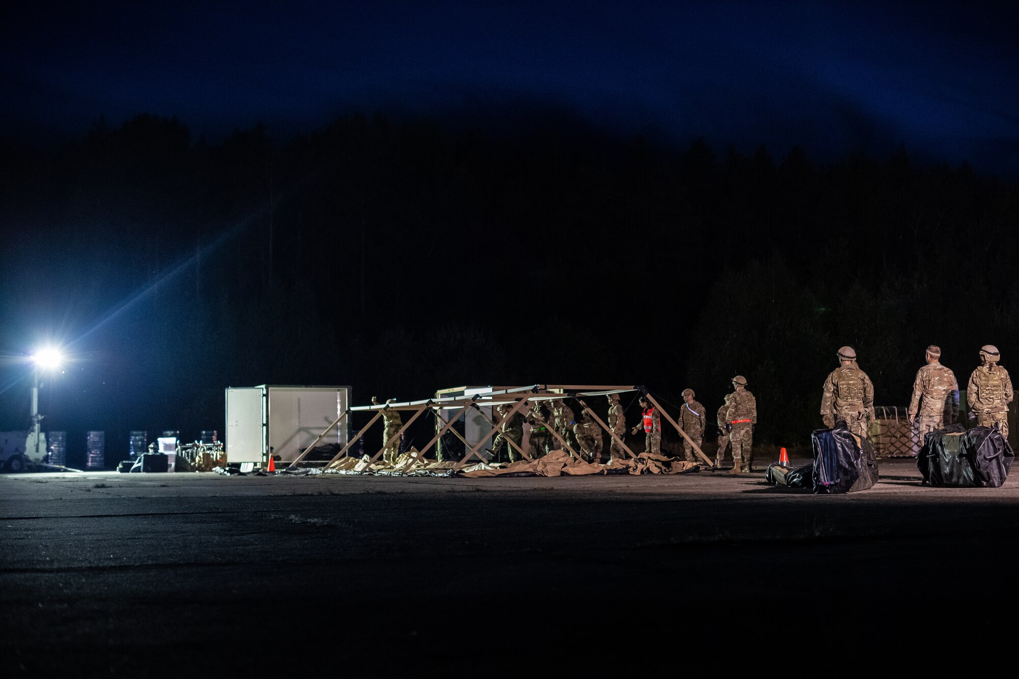 Airmen assigned to the 435th Contingency Response Group set up tents during exercise Agile Wolf 22 at Koszalin, Poland, Sept. 12, 2022. The 435th CRG is United States Air Forces in Europe's only expeditionary open-the-base force, comprised of 39 career fields which allow them to set up and run a fully functioning base within hours. (U.S. Air Force photo by Airman 1st Class Jared Lovett)