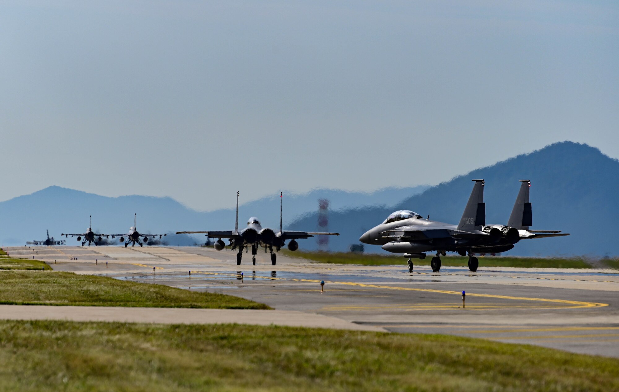 Republic of Korea Air Force F-15K Slam Eagles assigned to the 110th Fighter Squadron and U.S. Air Force F-16 Fighting Falcons assigned to the 8th Operations Group taxi on the runway during routine training at Kunsan Air Base, Republic of Korea, Sept. 22, 2022. Bilateral training events fulfill a vital role in fortifying the partnership between ROKAF and U.S. counterparts while also playing an integral part in the safety and security of the Indo-Pacific region. (U.S. Air Force Photo by Senior Airman Shannon Braaten)