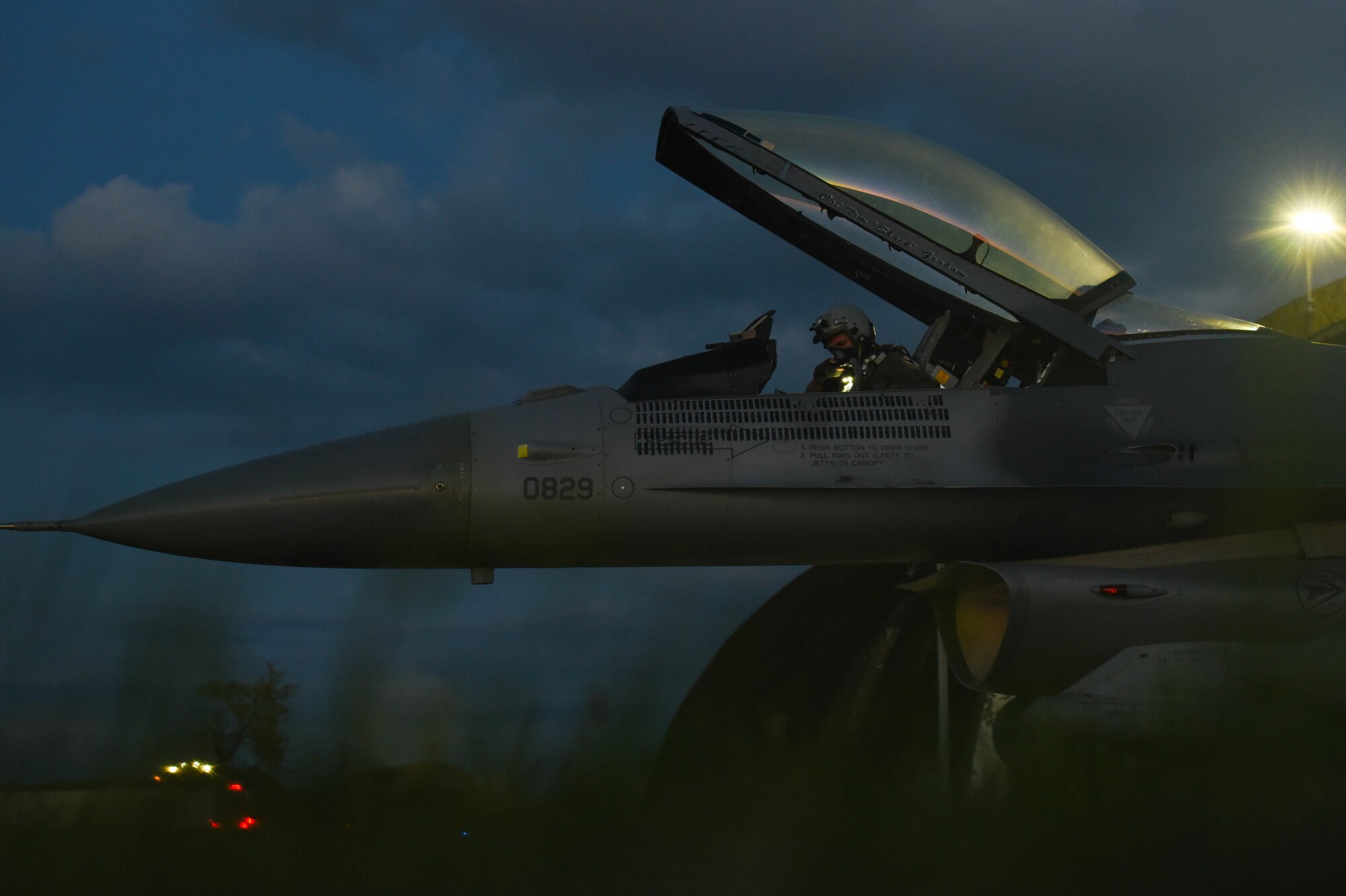 A pilot inspects his gear.