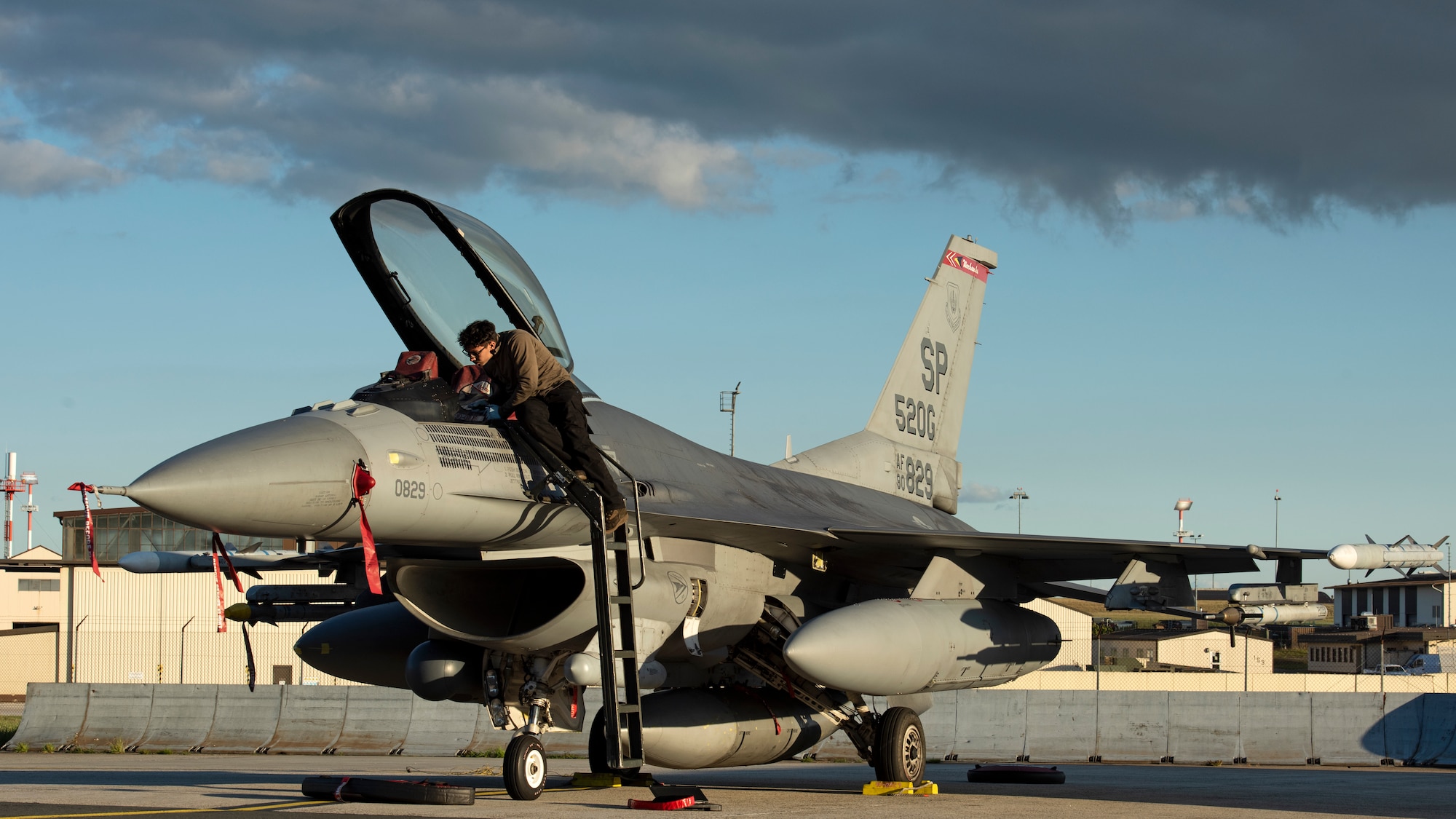 An Airman inspects the cockpit of an aircraft.