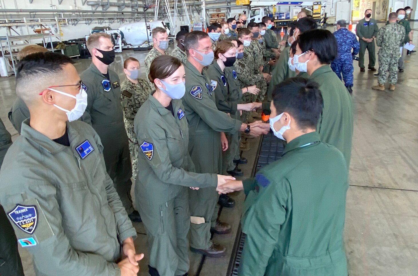 KADENA AIR BASE, Japan (Sept. 21, 2022) – Visiting members of Japan Maritime Self-Defense Force Air Reconnaissance Squadron (VQ) 81 greet Fleet Air Reconnaissance Squadron (VQ) 1 during Raijin 22-2, an annual unit exchange. Based out of Whidbey Island, Washington, the VQ-1 “World Watchers” are currently operating from Kadena Air Base in Okinawa, Japan. The squadron conducts naval operations as part of a rotational deployment to the U.S. 7th Fleet area of operations. (U.S. Navy photo by Mass Communication Specialist First Class Glenn Slaughter)