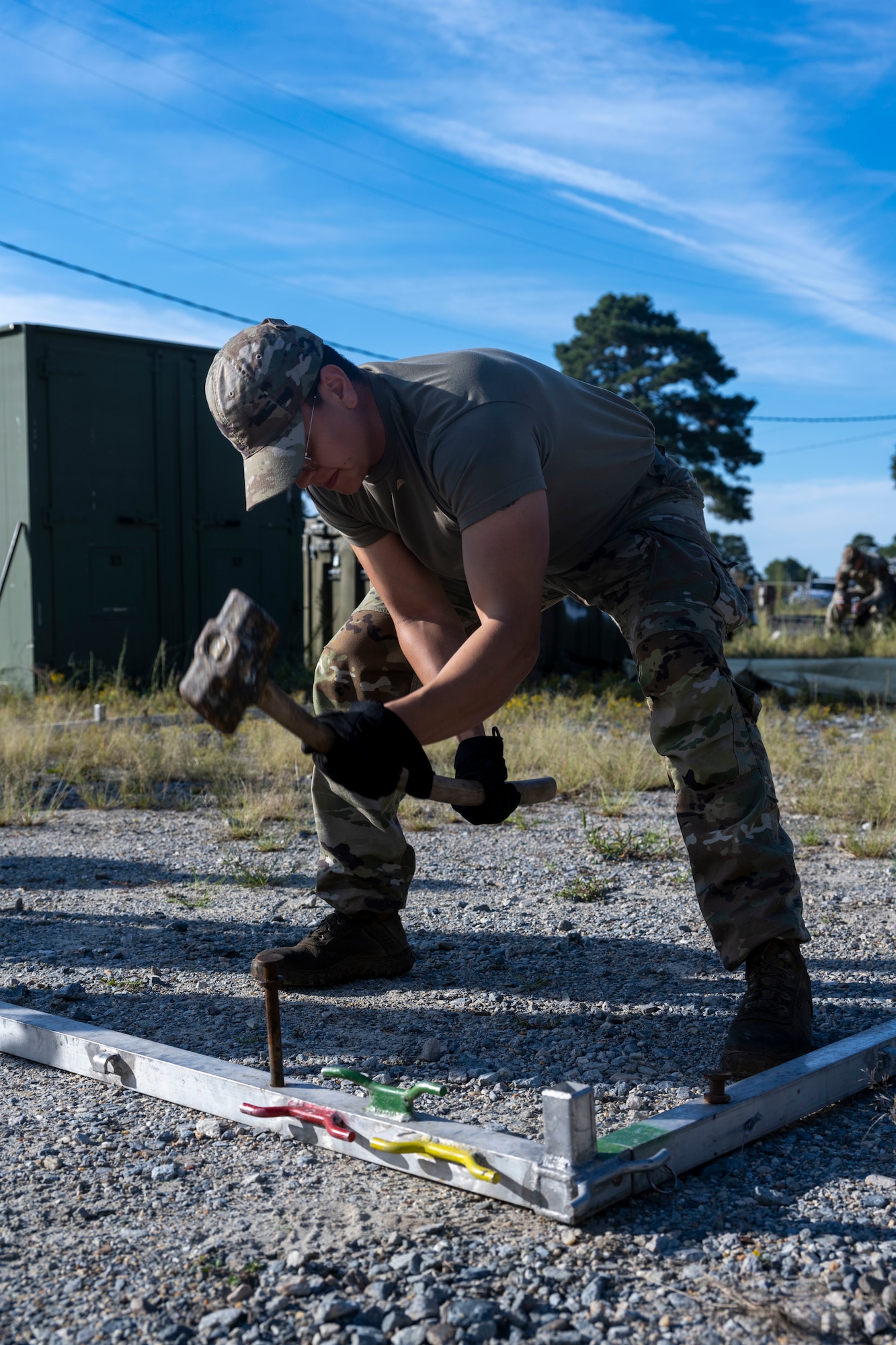 Senior Airman Alejandro Soto, 336th Fighter Generation Squadron weapons load crew member, secures a tent frame during a Multi-Capable Airman exercise at Seymour Johnson Air Force Base, North Carolina, Sept. 14, 2022. Airmen participating in the exercise were taught to do basic tasks outside of their usual specialty to become more well-rounded. (U.S. Air Force photo by Senior Airman Kevin Holloway)