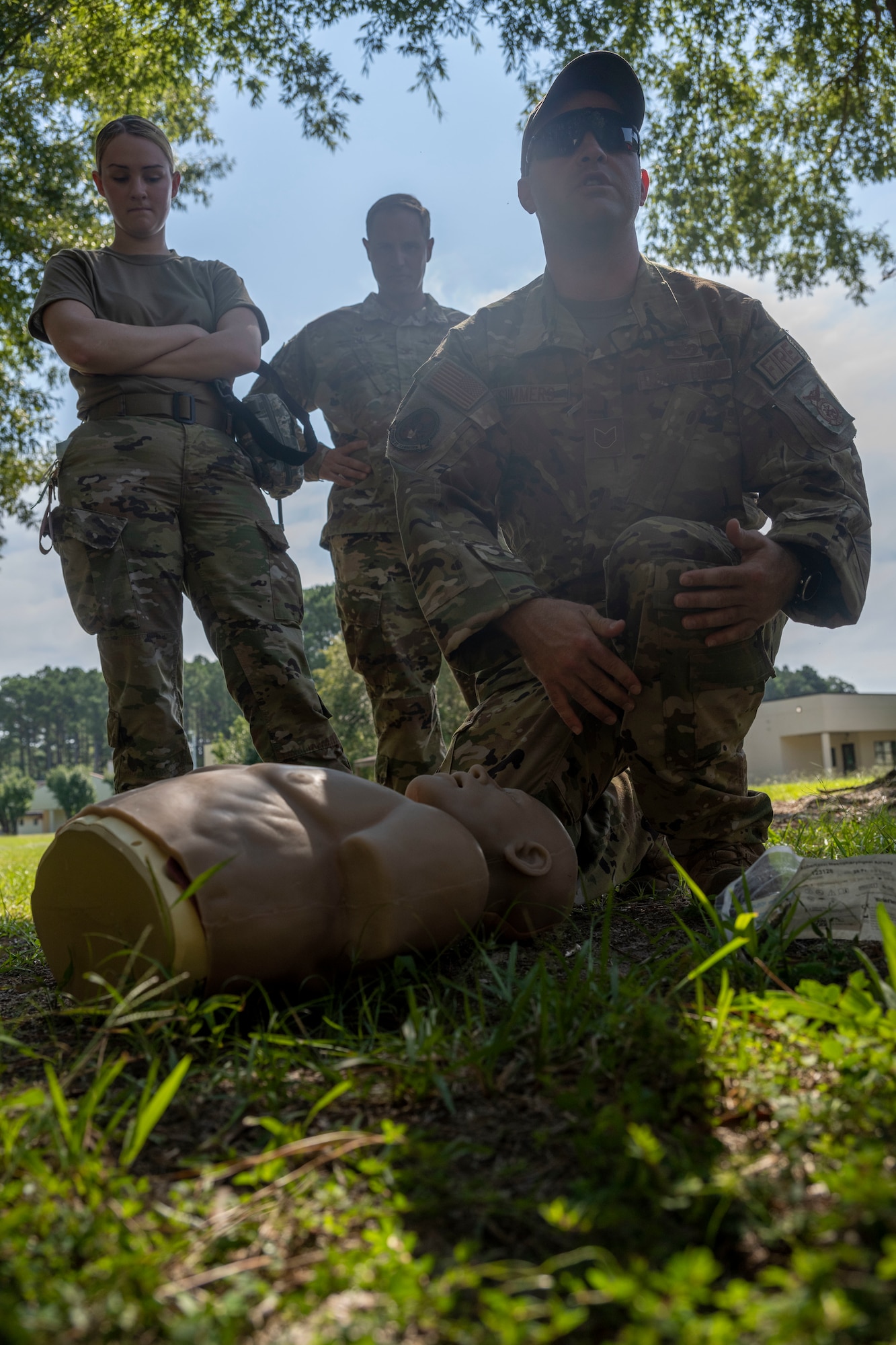 Tech. Sgt. James Summers, 4th Civil Engineer Squadron fire station chief, instructs Airmen on the proper procedure to assess a casualty's airways during Tactical Combat Casualty Care training in conjunction with a Multi-Capable Airman exercise at Seymour Johnson Air Force Base, North Carolina, Sept. 15, 2022. The TCCC course provides skills to assess and manage a combat casualty. (U.S. Air Force photo by Senior Airman Kevin Holloway)