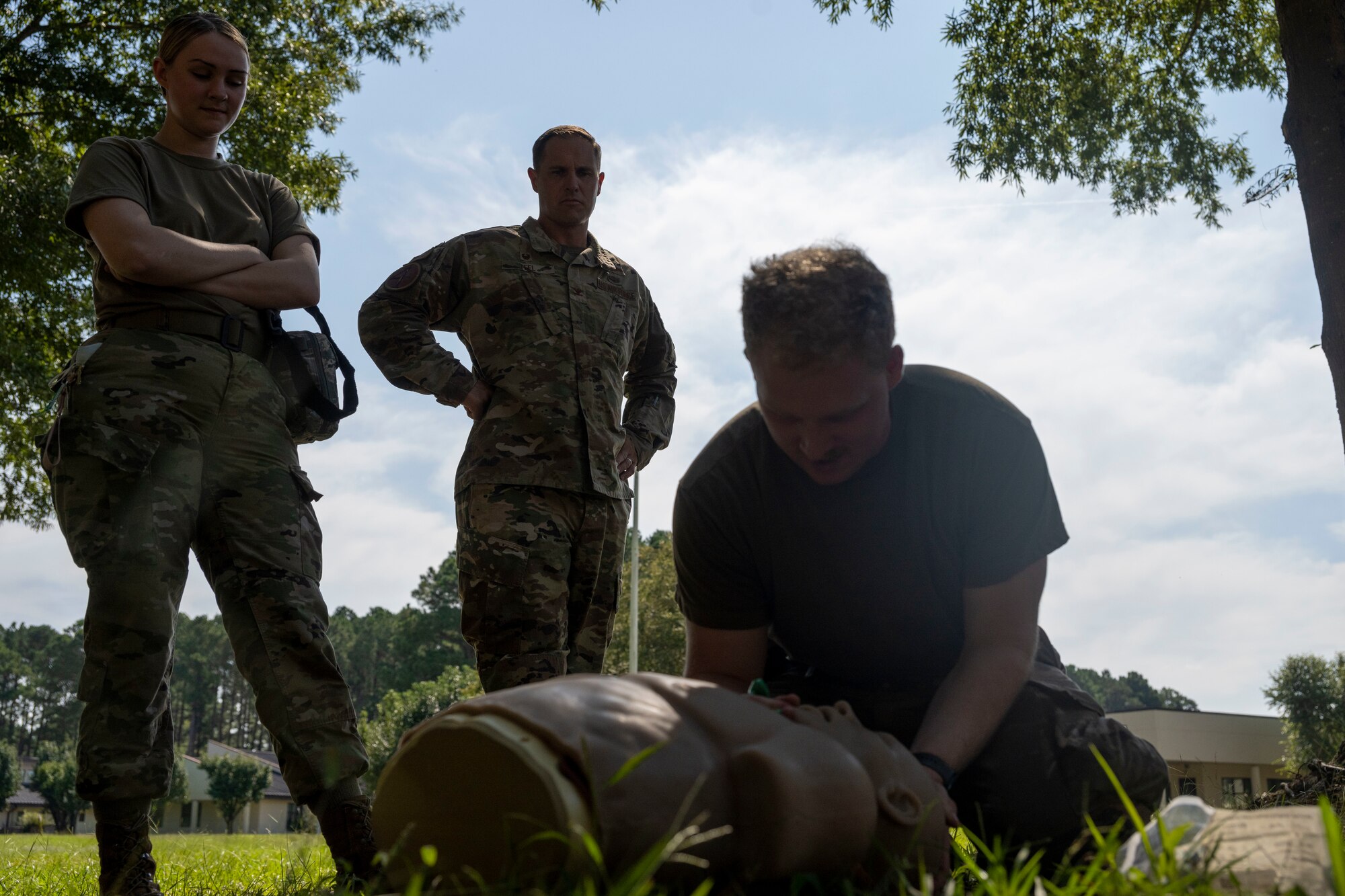 Col. Lucas Teel, 4th Fighter Wing commander, observes as Airman 1st Class Dante Bair, 4th Logistics Readiness Squadron material management specialist, practices the proper procedure to assess a casualty’s airways during Tactical Combat Casualty Care training, held with a Multi-Capable Airman exercise at Seymour Johnson Air Force Base, North Carolina, Sept. 15, 2022. The TCCC course provides skills to assess and manage a combat casualty from the moment an injury occurs. (U.S. Air Force photo by Senior Airman Kevin Holloway)