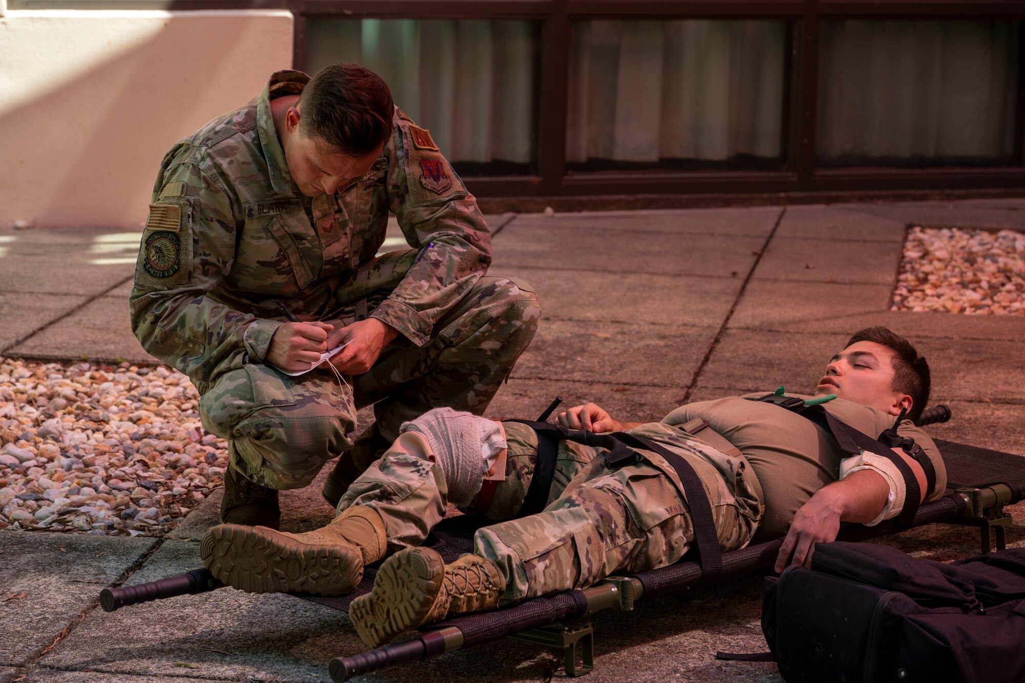 Senior Airman Matthew Blank, 335th Fighter Generation Squadron F-15E Strike Eagle integrated avionics specialist, fills out a Tactical Combat Casualty Care card for a simulated injury during a Multi-Capable Airman exercise at Seymour Johnson Air Force Base, North Carolina, Sept. 15, 2022. The TCCC course provides skills to assess and manage a combat casualty from the moment an injury occurs until they get a higher level of medical care. (U.S. Air Force photo by Senior Airman Kevin Holloway)