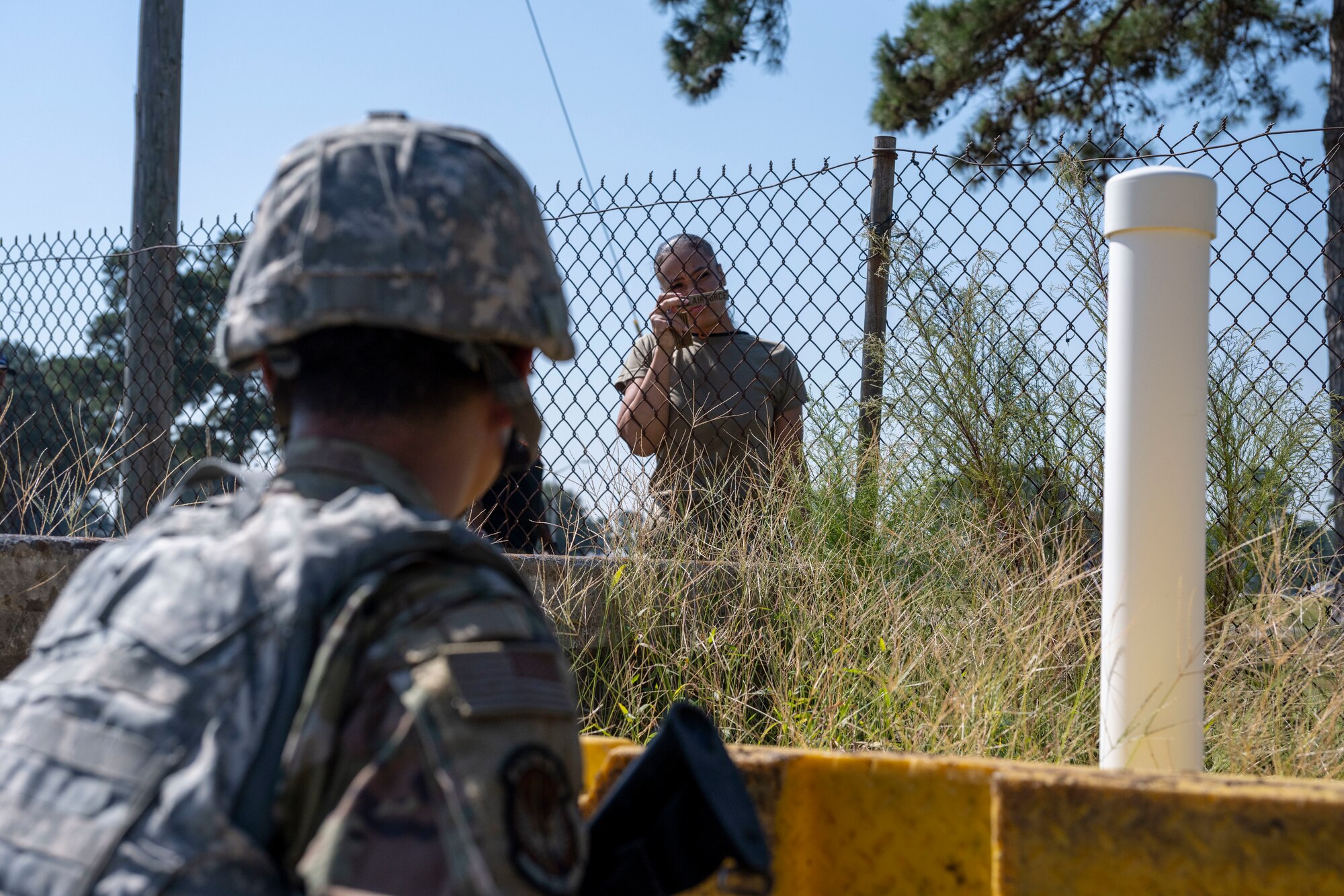 Tech. Sgt. Iree Edwards, Multi-Capable Airman training instructor, simulates a perimeter security during a Multi-Capable Airman field training exercise at Seymour Johnson Air Force Base, North Carolina, Sept. 20, 2022. Edward’s goal was to try and deceive the Airmen into letting her within the perimeter, which may happen when providing perimeter security. (U.S. Air Force photo by Senior Airman Kevin Holloway)