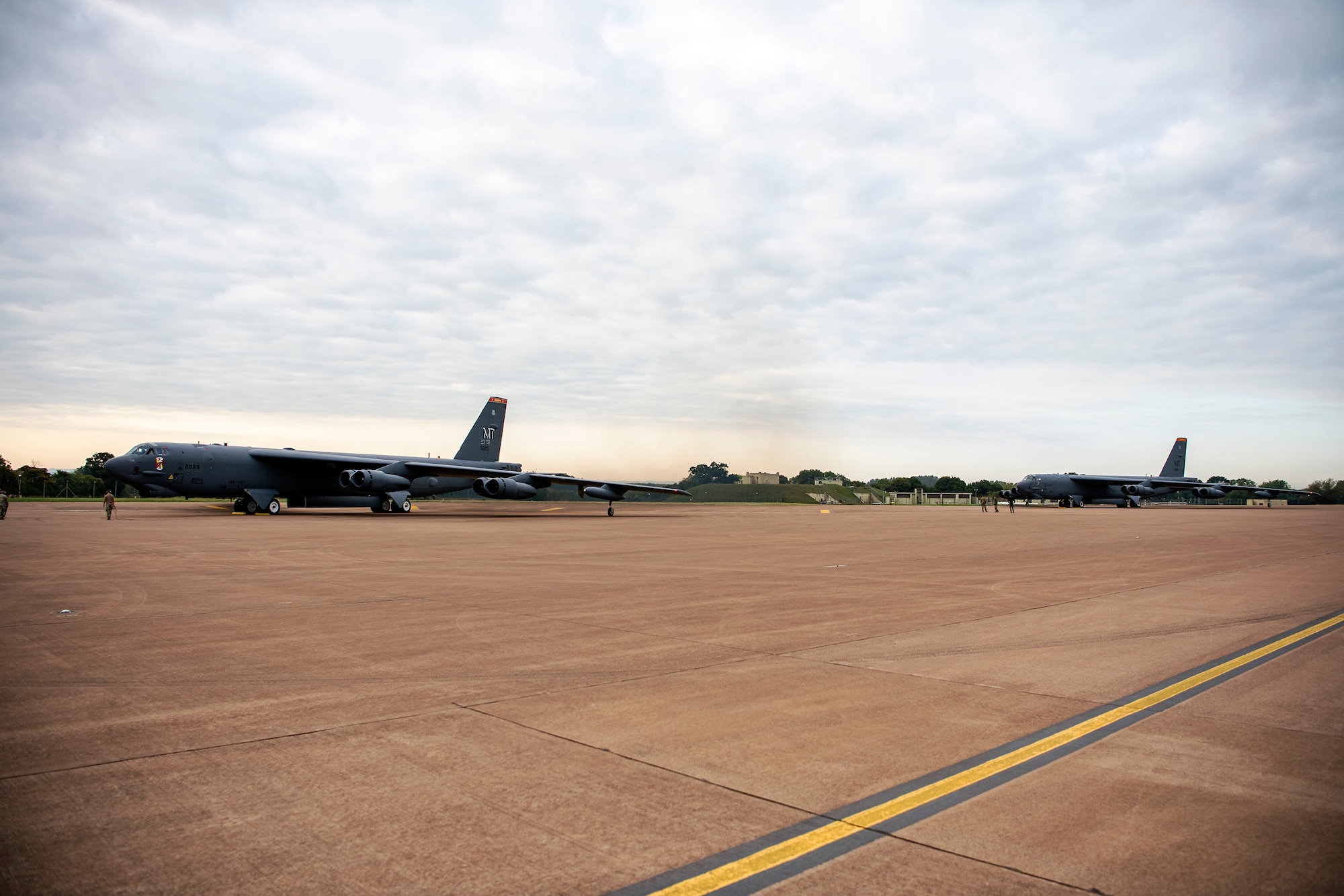 B-52 Stratofortress aircraft assigned to the 23rd Expeditionary Bomb Squadron que on the flightline prior to takeoff at RAF Fairford, United Kingdom, Sept. 21, 2022. A Bomber Task Force is the global employment of U.S. strategice bombers, providing strategic military advantage to achehive national and combatant commander objectives. (U.S. Air Force photo by Staff Sgt. Eugene Oliver)