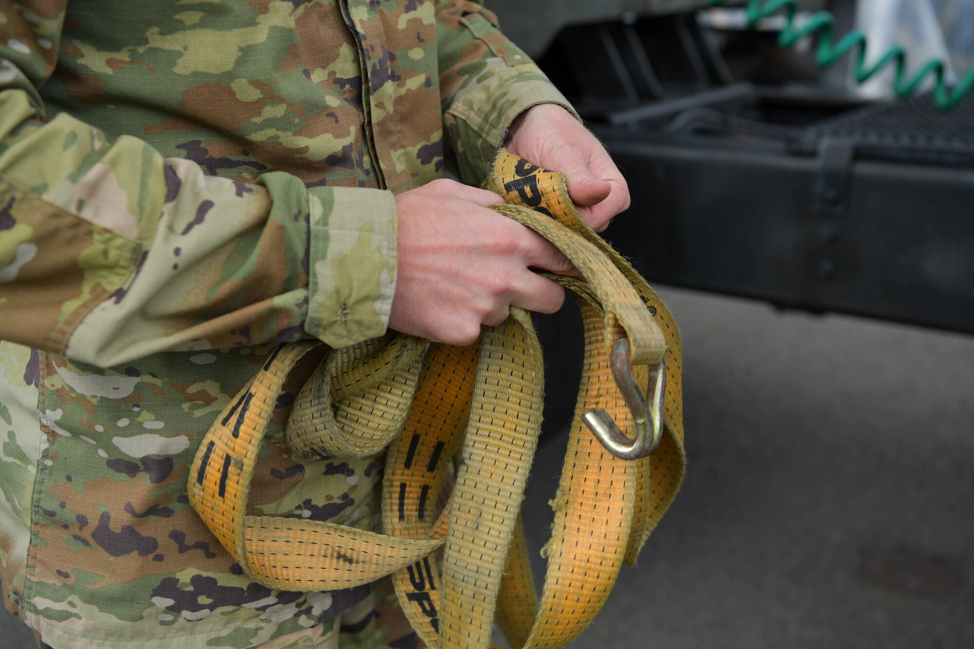Man secures cargo on vehicle
