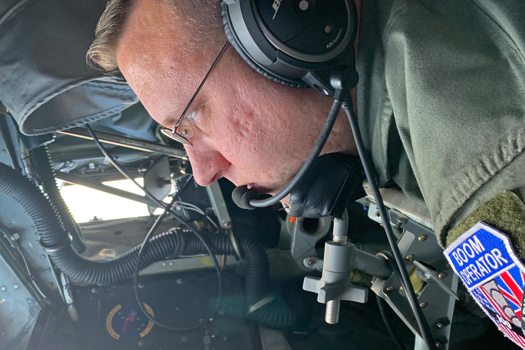 U.S. Air Force Master Sgt. Chad Holloway, 351st Air Refueling Wing boom operator, prepares the boom to refuel receiving aircraft over the North Sea during exercise Cobra Warrior 22, Sept. 21, 2022. The U.S. Air Force is engaged, postured, and ready with credible force to assure, deter and defend in an increasingly complex security environment. (U.S. Air Force photo by Tech. Sgt. Anthony Hetlage)