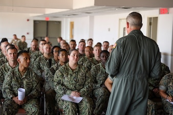 Rear Adm. Pete Garvin, commander, Naval Education and Training Command, speaks with first class petty officers, selected for promotion to chief petty officer, during an all-hands call at Naval Air Station Pensacola, Florida, Sept. 22, 2022.