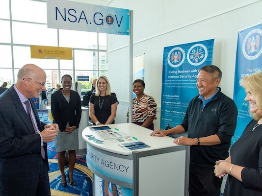NSA Deputy Director George Barnes checks out the agency's booth exhibit at the 2022 Intelligence and National Security Summit.