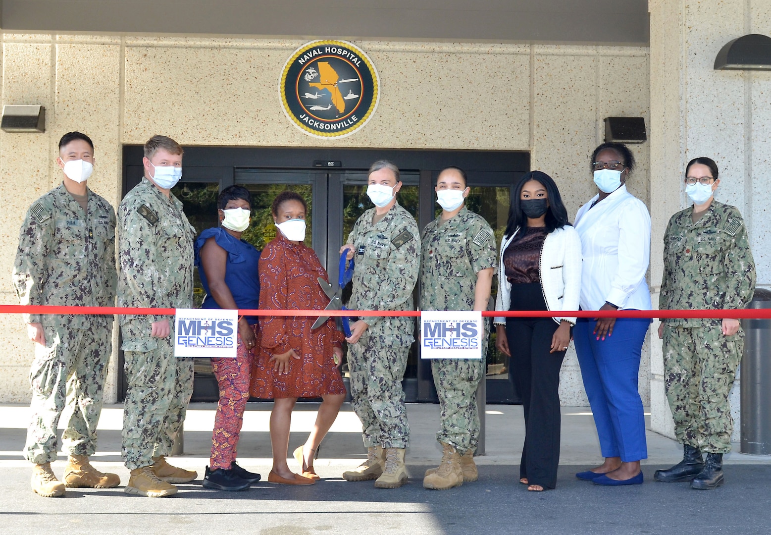 JACKSONVILLE, Fla. (Sept. 24, 2022) – Capt. Sharon House, Naval Hospital Jacksonville director and Navy Medicine Readiness and Training Command Jacksonville commander, together with the command’s Military Health System (MHS) GENESIS team, prepare to cut the ceremonial ribbon for the new electronic health record system MHS GENESIS on September 24 at the hospital.  The ribbon cutting recognized the launch of the new electronic health record at the hospital and its Naval Branch Health Clinics Jacksonville, Key West and Mayport.  (U.S. Navy photo by Yan Kennon, Naval Hospital Jacksonville/Released).