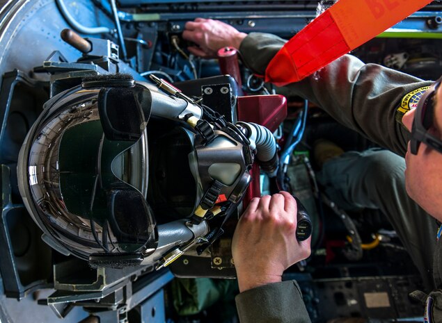 A pilot connects a USB charge cable, designed by Tech. Sgt. Flanagan, to the U-2 Dragon Lady July 26, 2022, at Beale Air Force Base, California. The new charging cable enables Airmen to charge equipment during long duration operational test flights. (U.S. Air Force photo by Staff Sgt. Colville McFee)