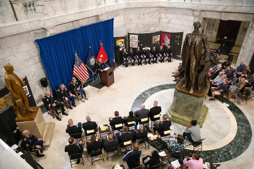 Army Maj. Jack Rachau introduces the newly commissioned officers in a ceremony at the Kentucky State Capitol Rotundra in Frankfort, Ky. on Sept. 24, 2022. The new officers will be pinned by family and friends at the ceremony as part of commissioning tradition. (U.S. Army photo by Andy Dickson)