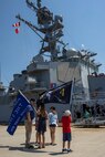 NORFOLK, Va. (August 4, 2022) Family of Sailors aboard the Arleigh Burke-class guided-missile destroyer USS Bulkeley (DDG 84) wave the ship’s battle flag as it prepares to depart Naval Station Norfolk August 4, 2022