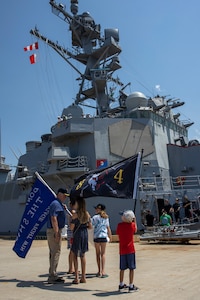 NORFOLK, Va. (August 4, 2022) Family of Sailors aboard the Arleigh Burke-class guided-missile destroyer USS Bulkeley (DDG 84) wave the ship’s battle flag as it prepares to depart Naval Station Norfolk August 4, 2022