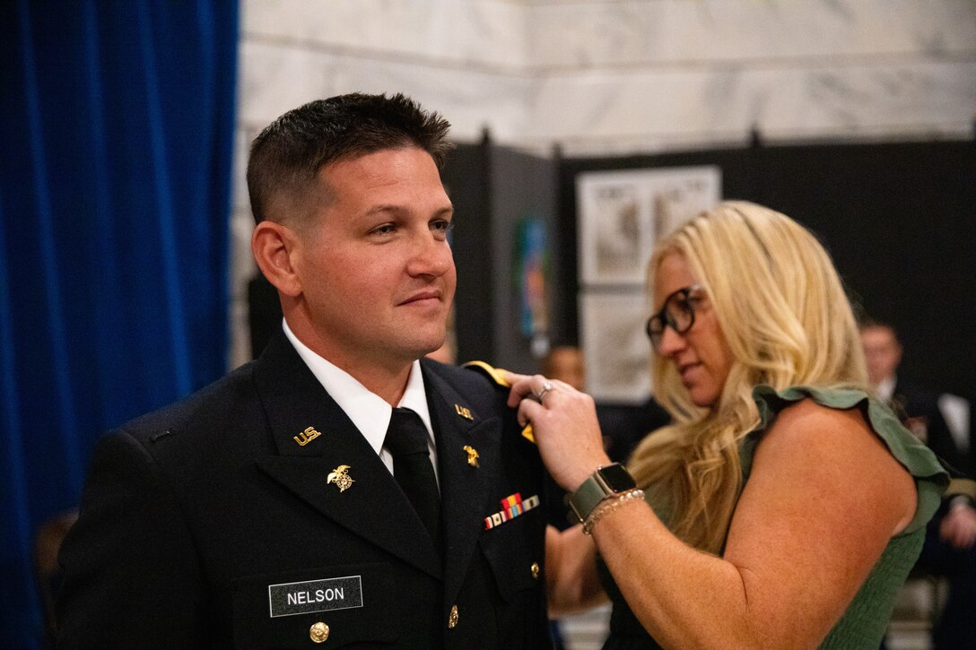 Army officer candidate Steven Nelson is pinned second lieutenant by his wife during the officer commissioning ceremony at the Kentucky State Capitol rotunda in Frankfort, Ky. on Sept. 24, 2022. Nelson and six other officer candidates were commissioned as officers in the Kentucky National Guard by friends and family. (U.S. Army photo by Andy Dickson)