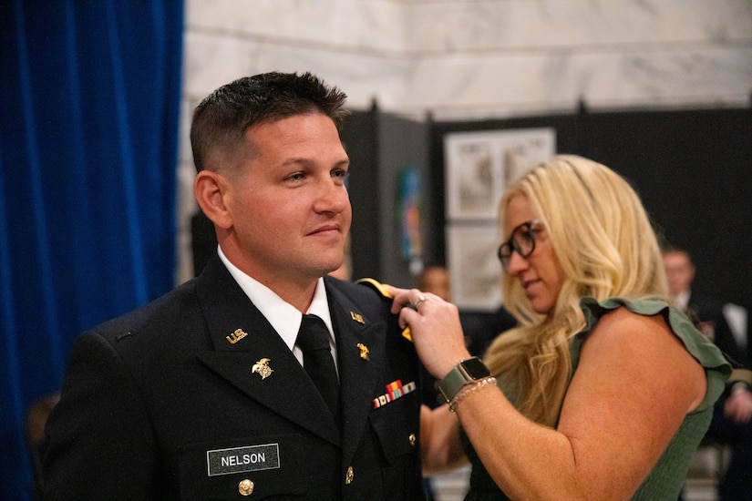 Army officer candidate Steven Nelson is pinned second lieutenant by his wife during the officer commissioning ceremony at the Kentucky State Capitol rotunda in Frankfort, Ky. on Sept. 24, 2022. Nelson and six other officer candidates were commissioned as officers in the Kentucky National Guard by friends and family. (U.S. Army photo by Andy Dickson)
