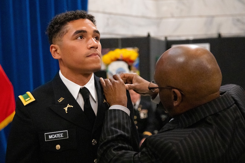 Army officer candidate Tevin McAtee is pinned second lieutenant by his uncle during the officer commissioning ceremony at the Kentucky State Capitol rotunda in Frankfort, Ky. on Sept. 24, 2022. McAtee and six other officer candidates were commissioned as officers in the Kentucky National Guard by friends and family. (U.S. Army photo by Andy Dickson)