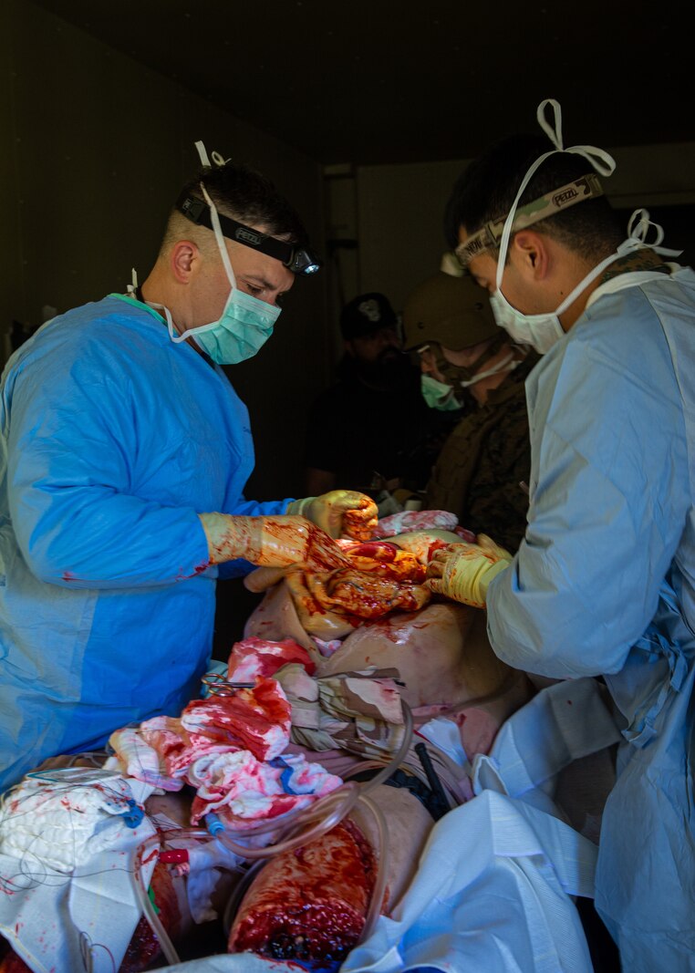 U.S. Sailors with 1st Medical Battalion, 1st Marine Logistics Group, I Marine Expeditionary Force, conduct surgery on a simulated casualty during a field training exercise at Camp Pendleton, California, Jan. 24, 2022